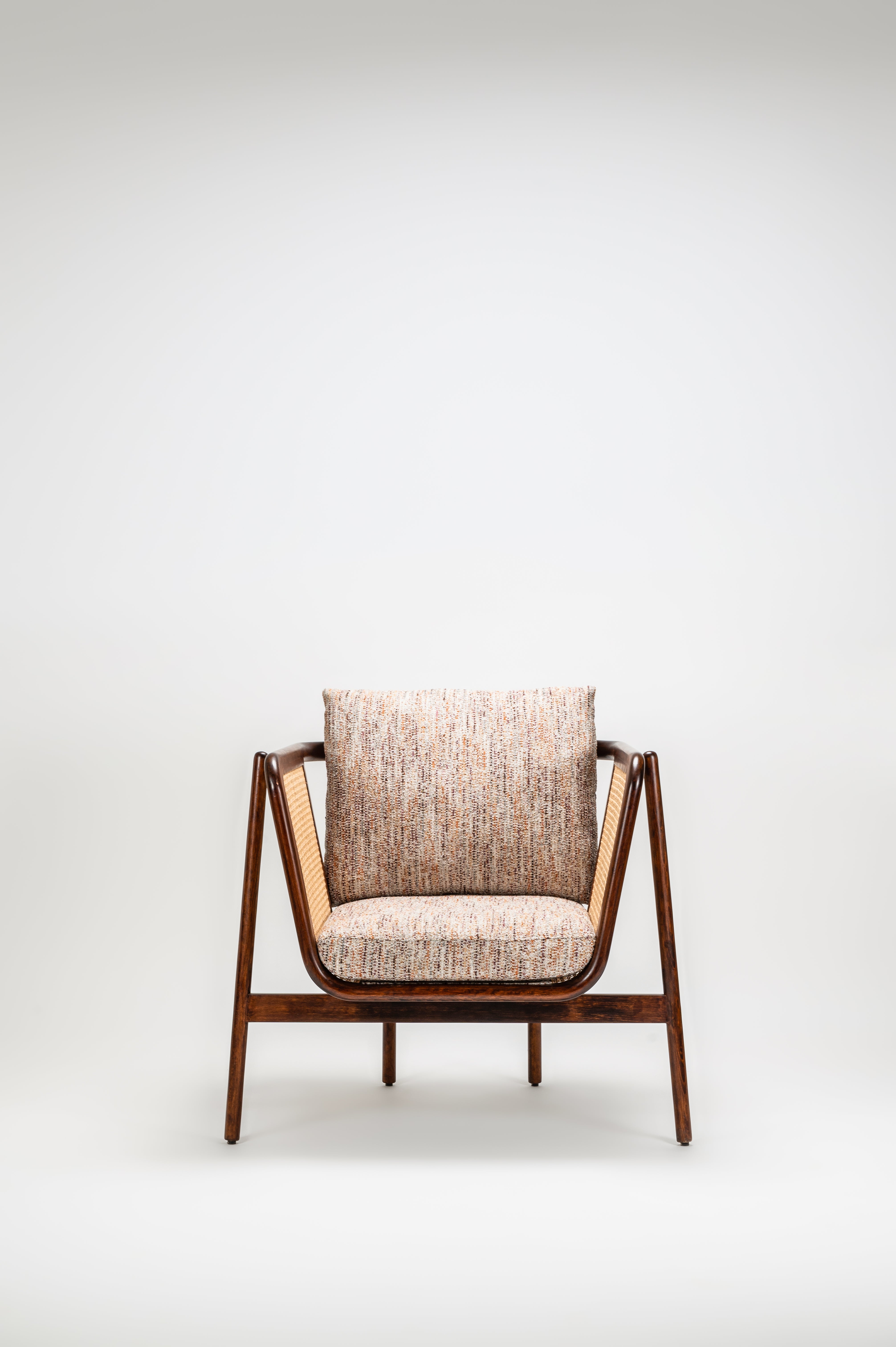 Modern chair with wooden frame and fabric cushion on a white background