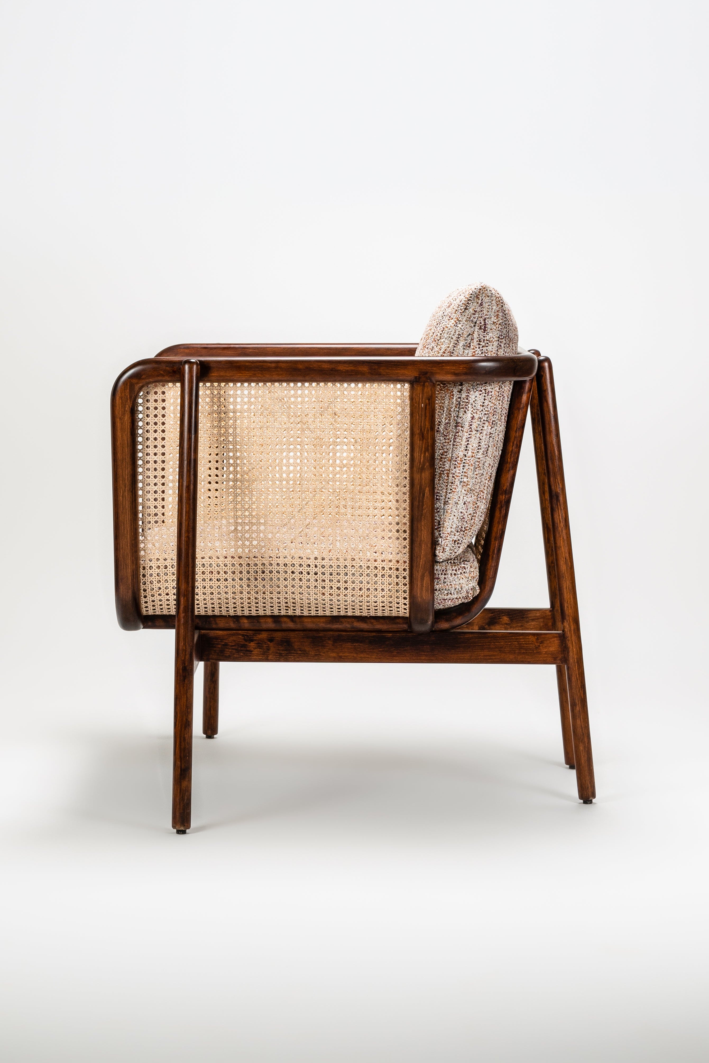 Chair with woven backrest and wooden frame on a white background
