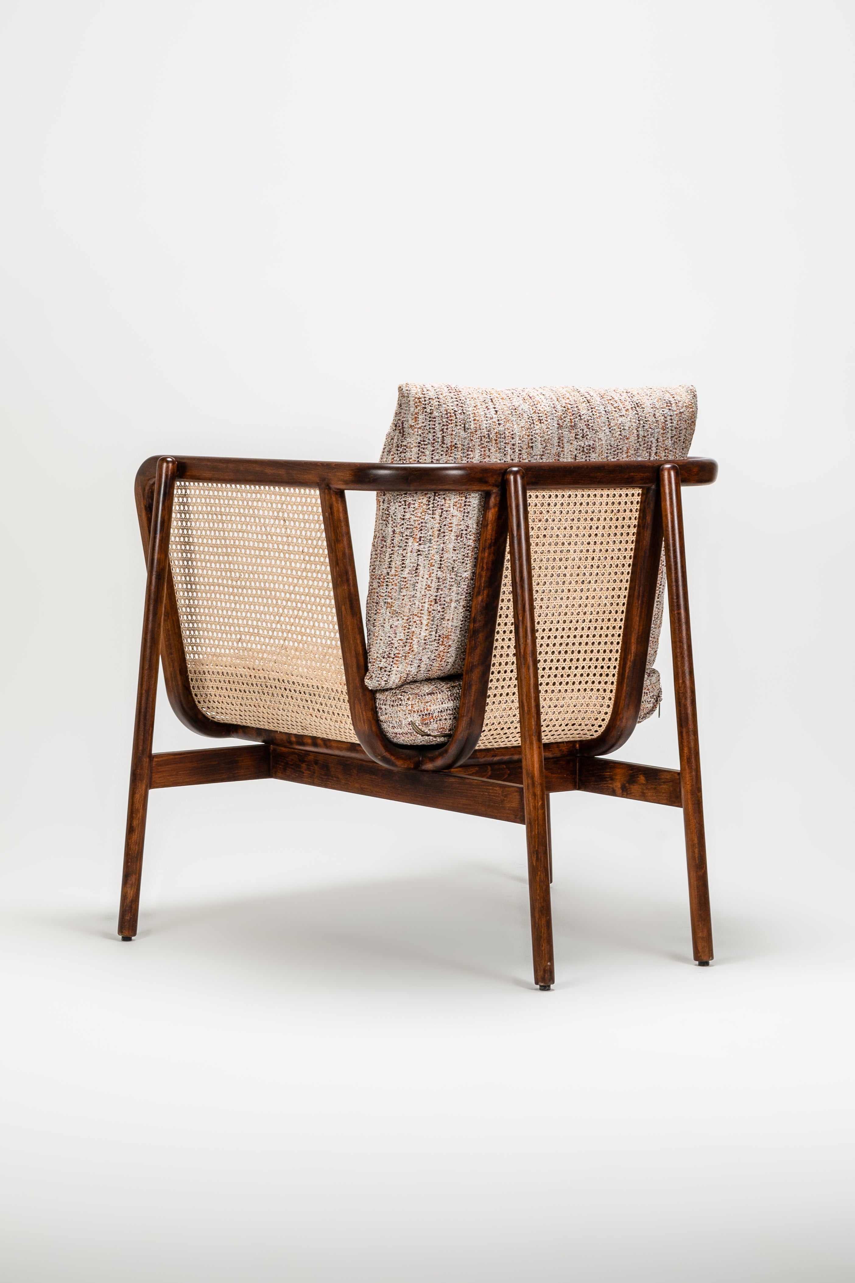Wooden armchair with woven backrest on a white background
