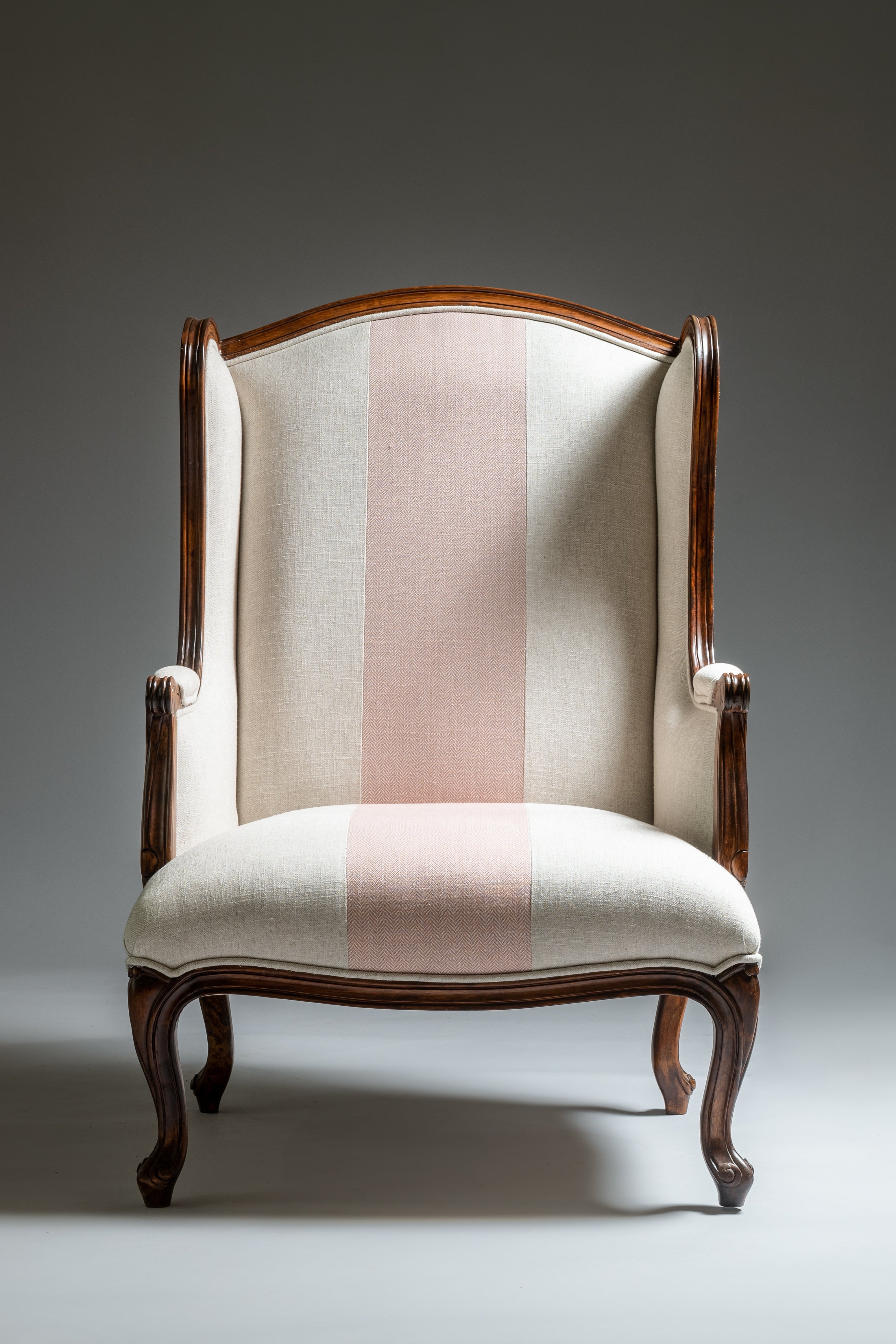 Chair with striped cushion on a gray background