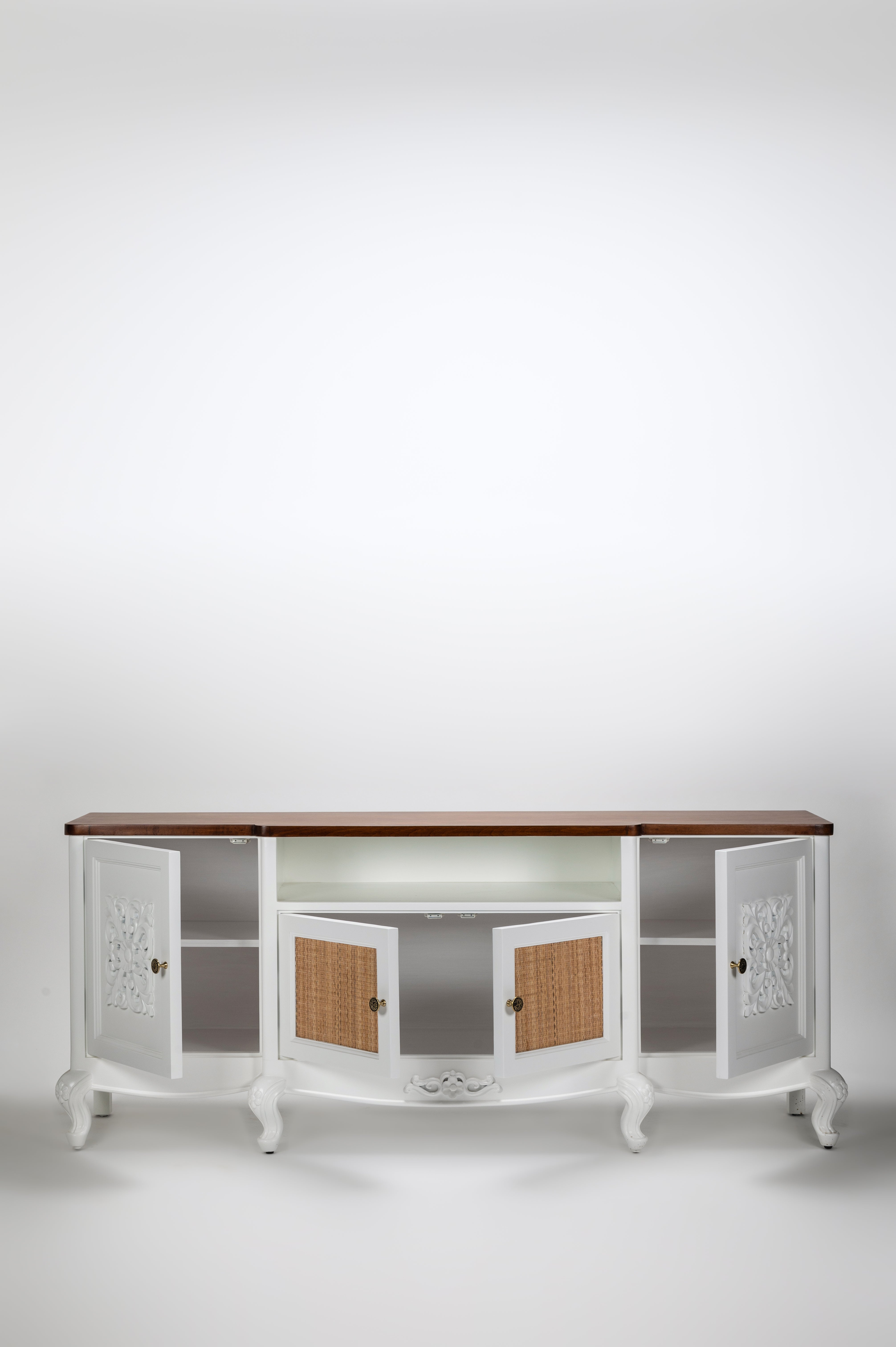 White sideboard with wooden top and decorative doors on a white background