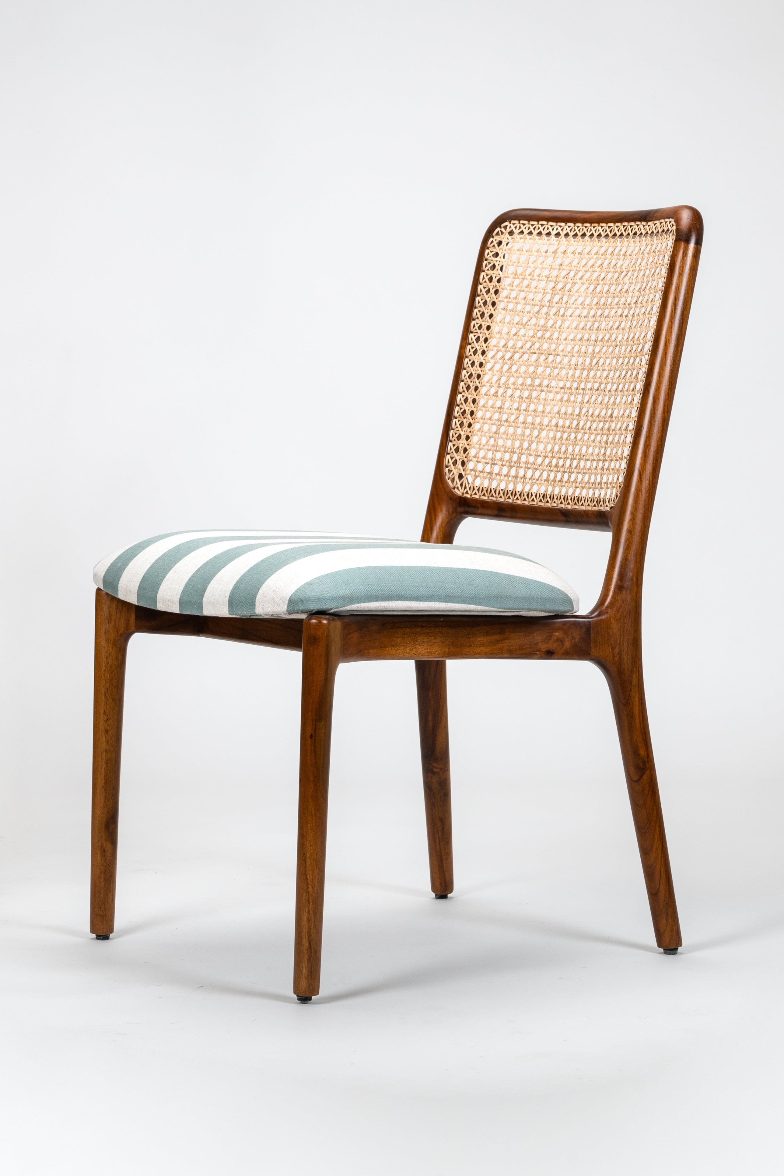 Chair with wicker back and striped cushion on a white background
