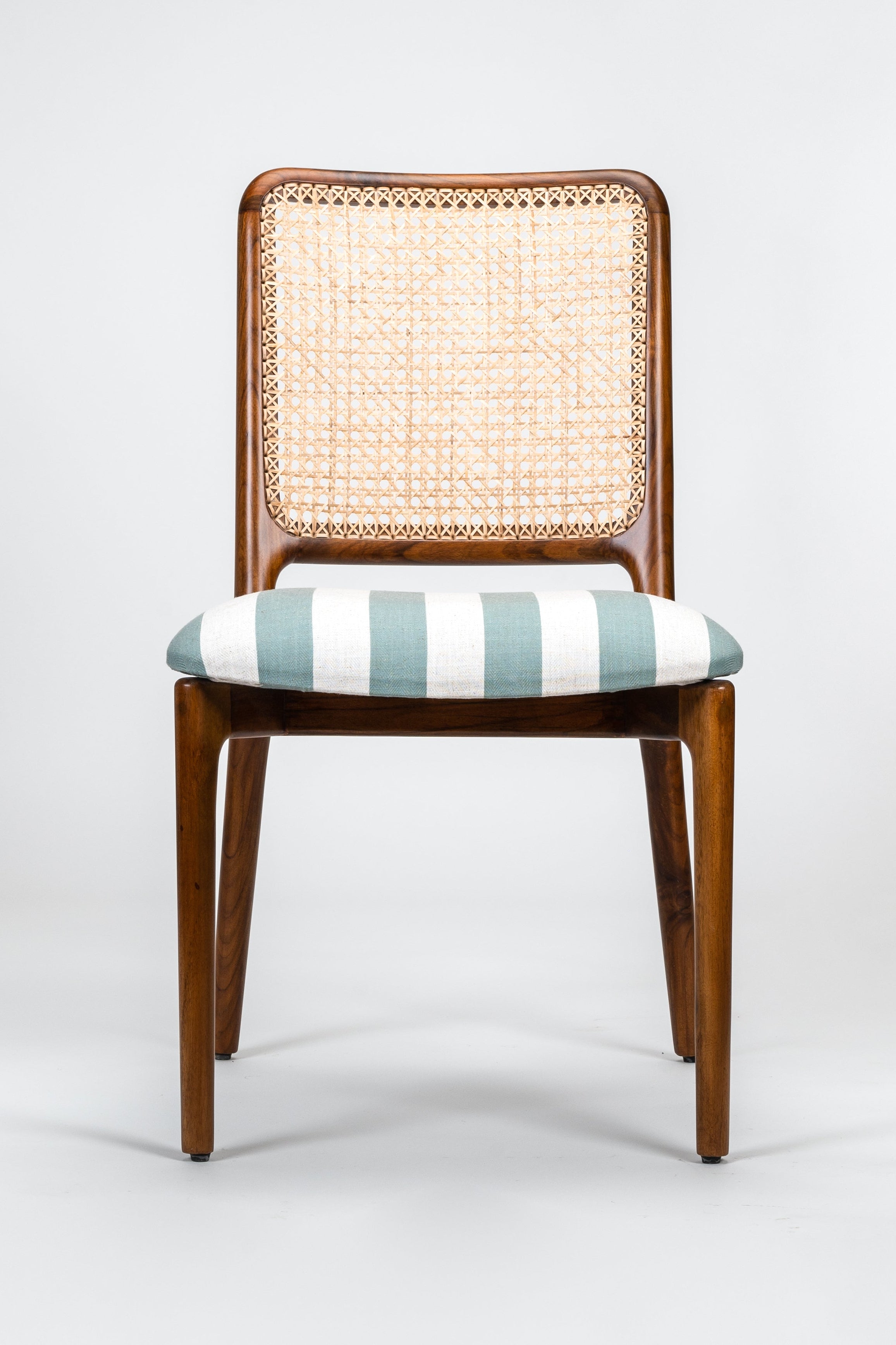 Chair with wicker backrest and striped cushion on a white background