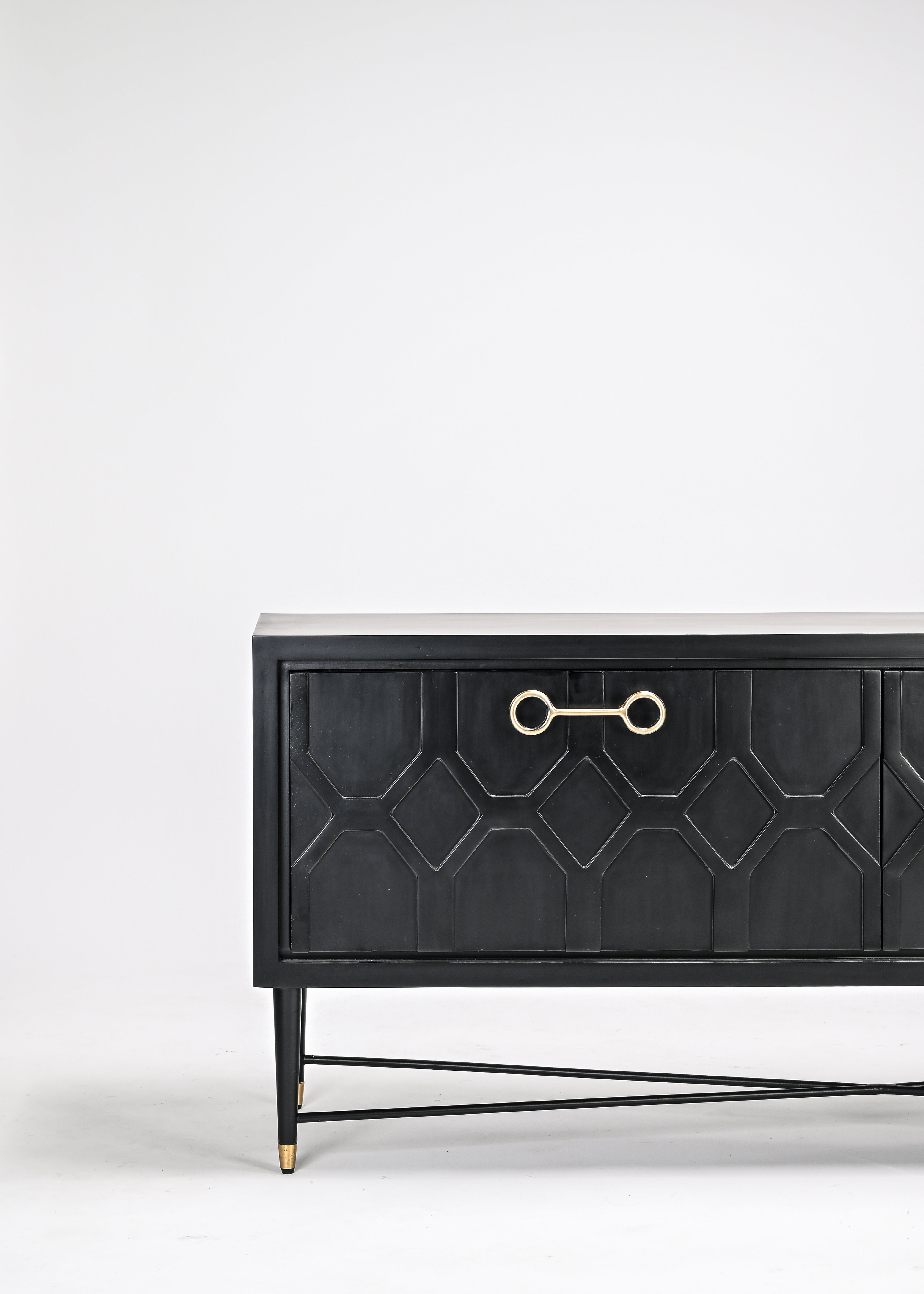 Black dresser with geometric design and gold handle on a white background