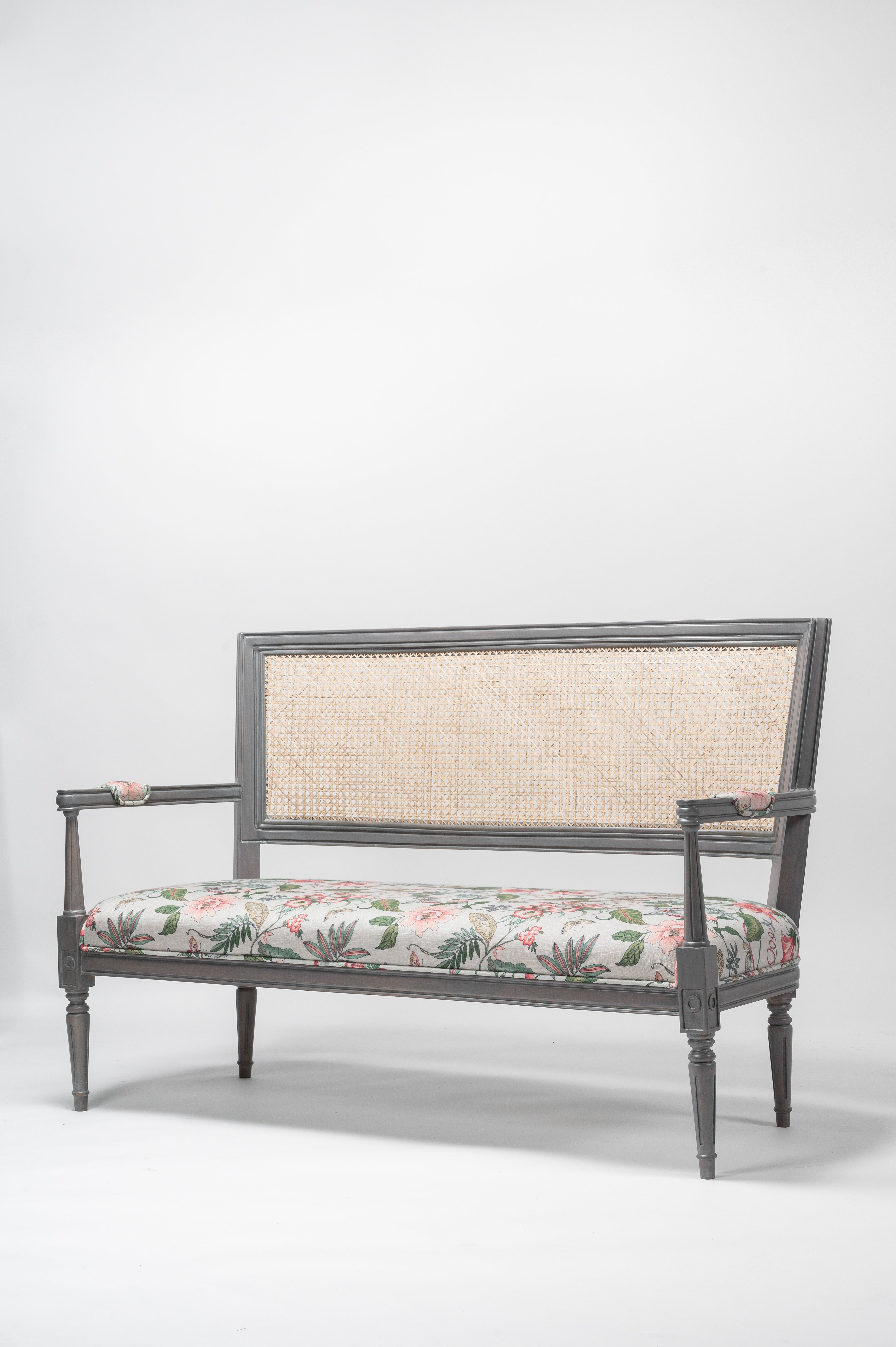 Decorative bench with floral cushion on a white background