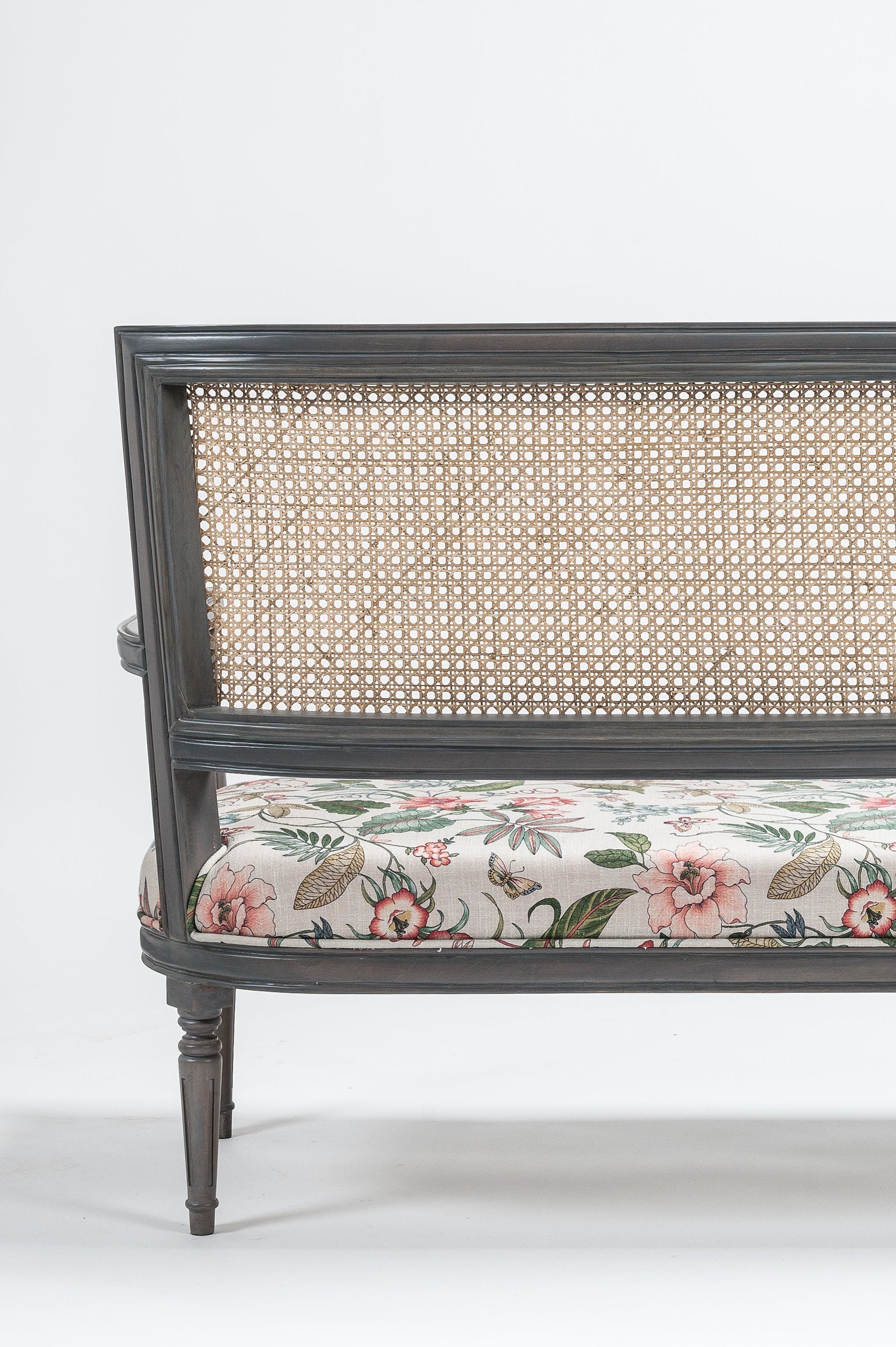Decorative bench with floral cushion on a white background