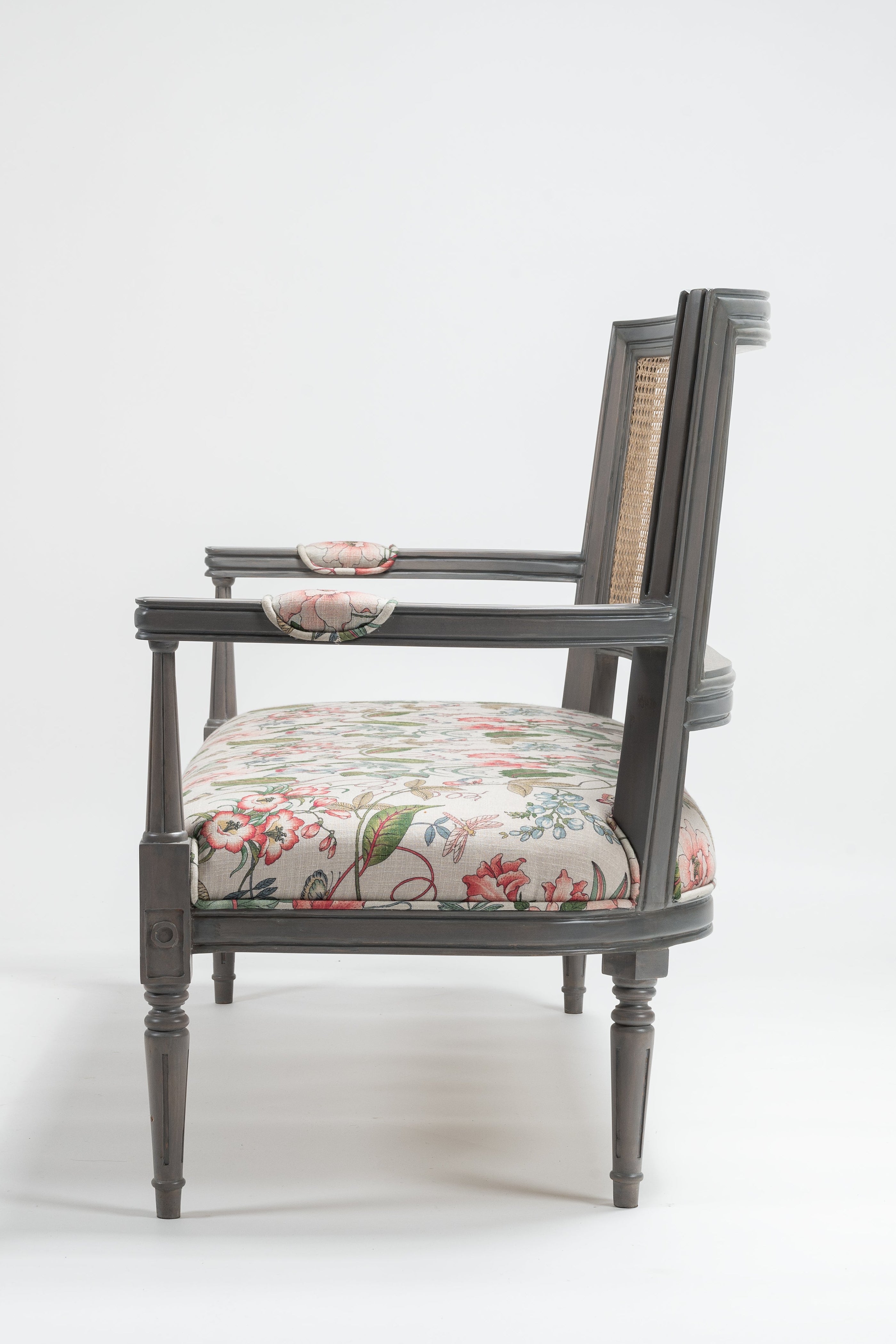 Chair with floral cushion on a white background