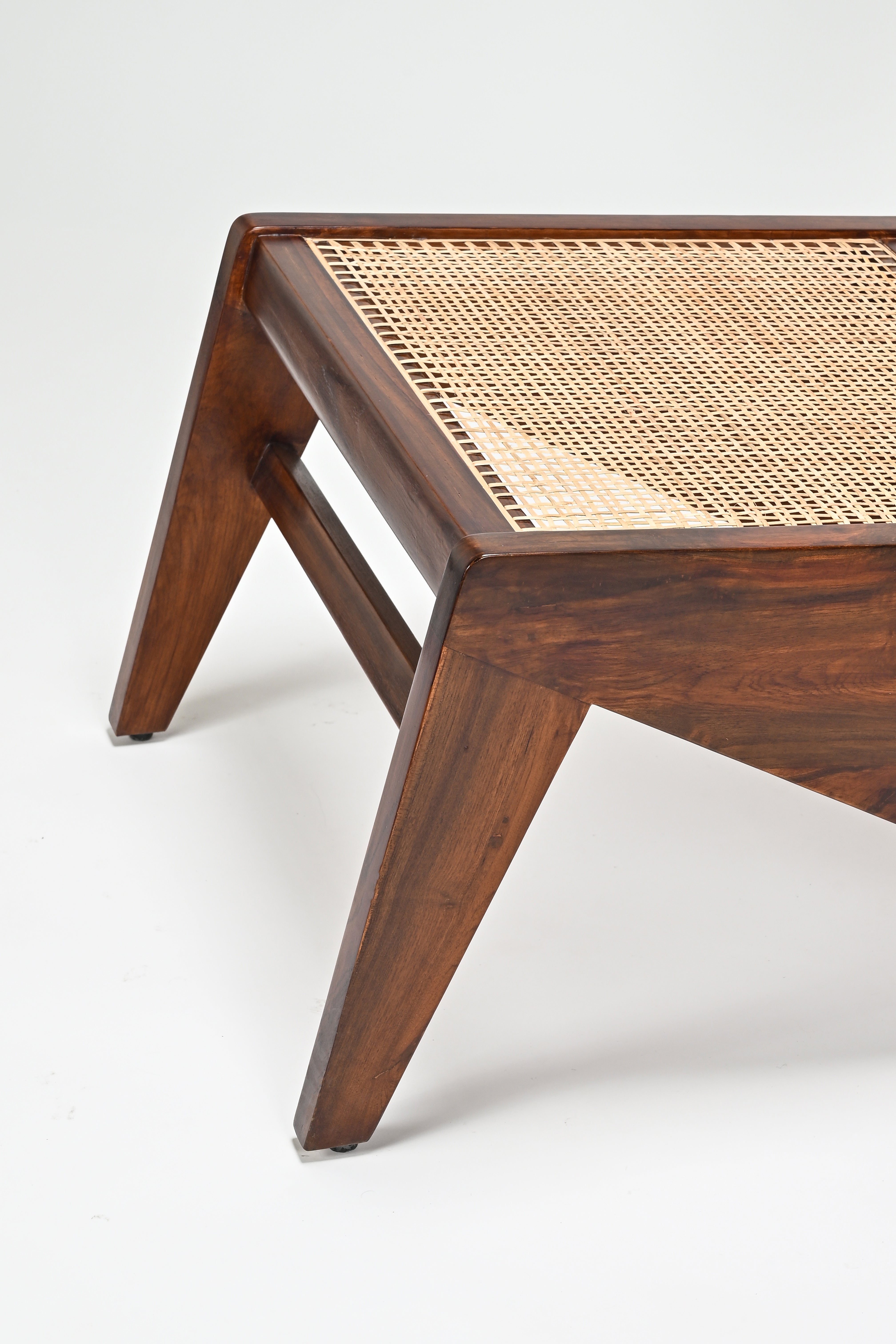 Wooden coffee table with wicker top on a white background