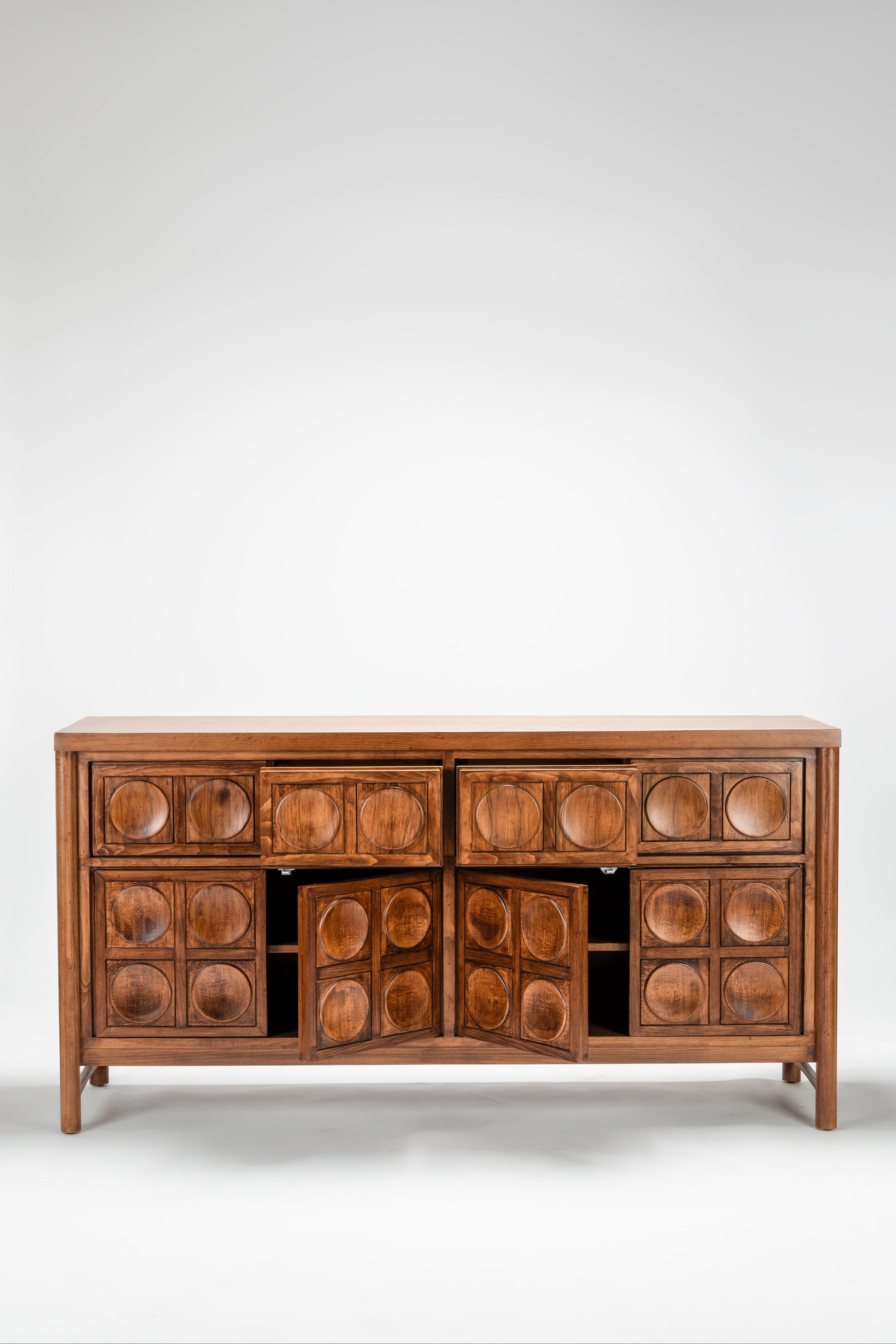 Wooden sideboard with circular patterns on a white background