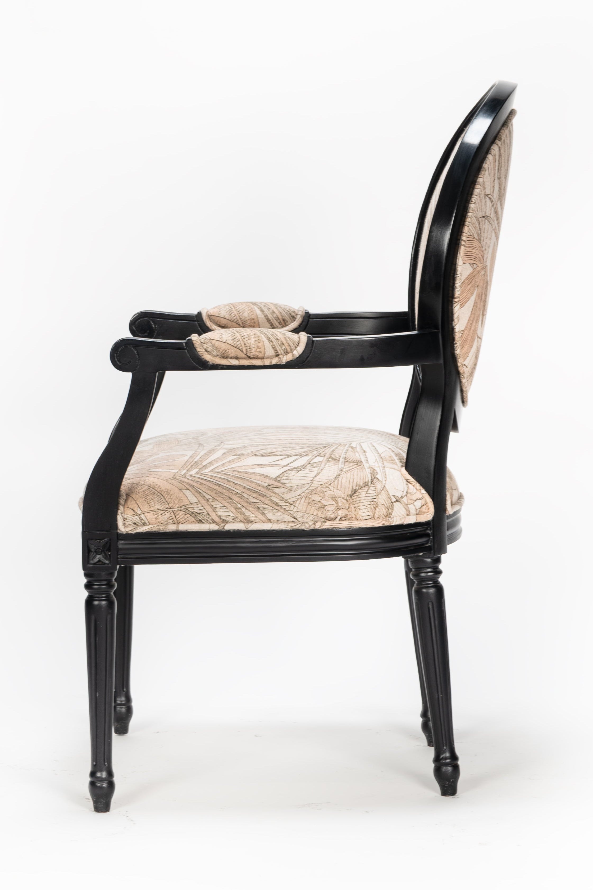 Chair with black frame and beige cushion on a white background