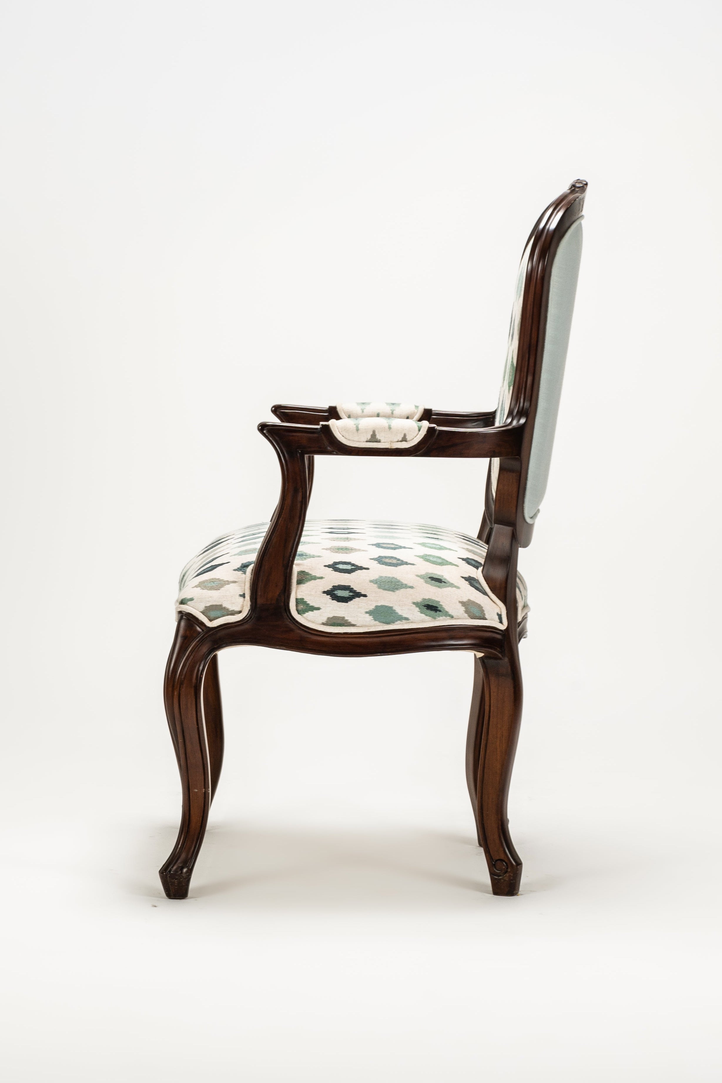 Wooden chair with patterned cushion on a white background