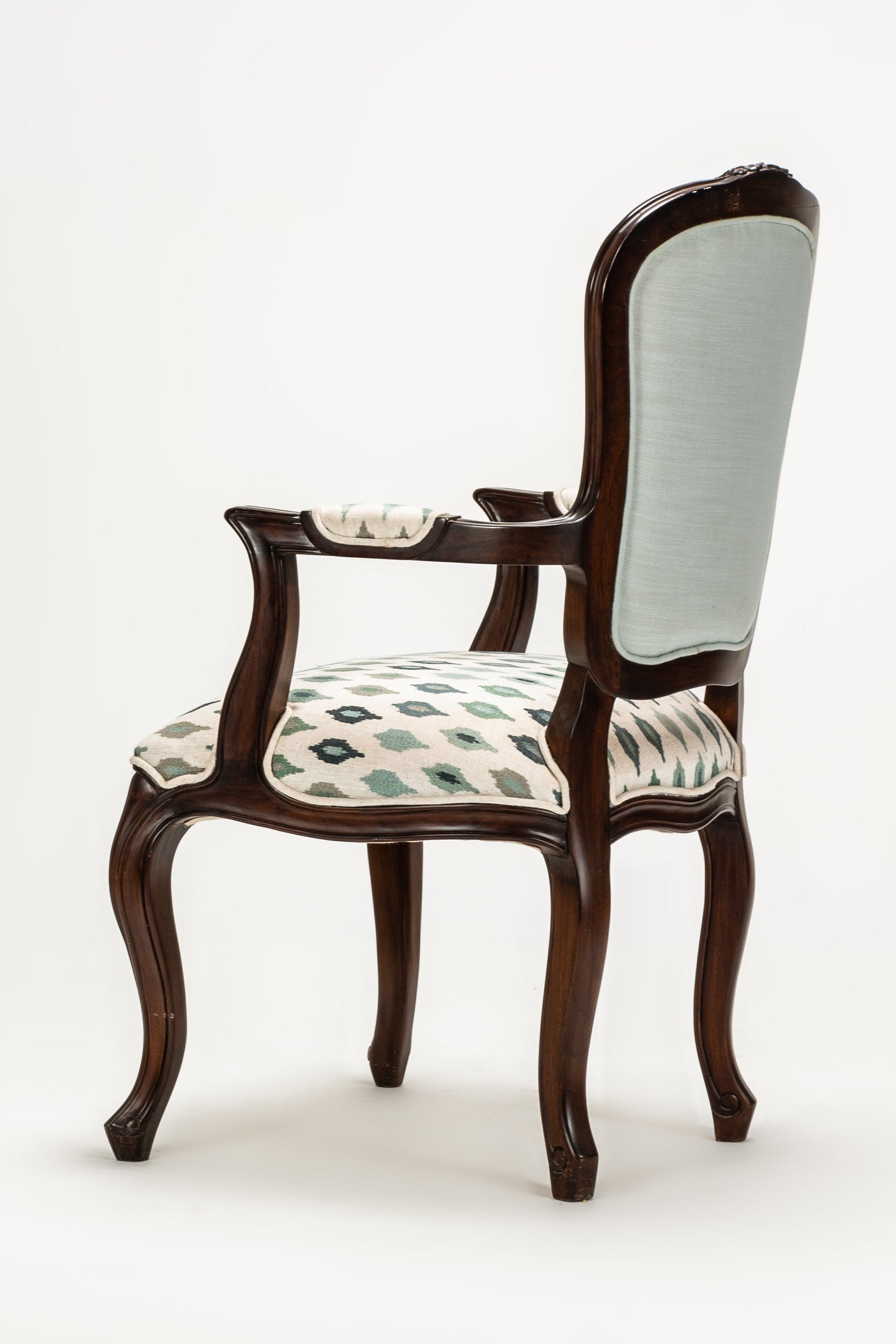 Wooden chair with patterned cushion on a white background