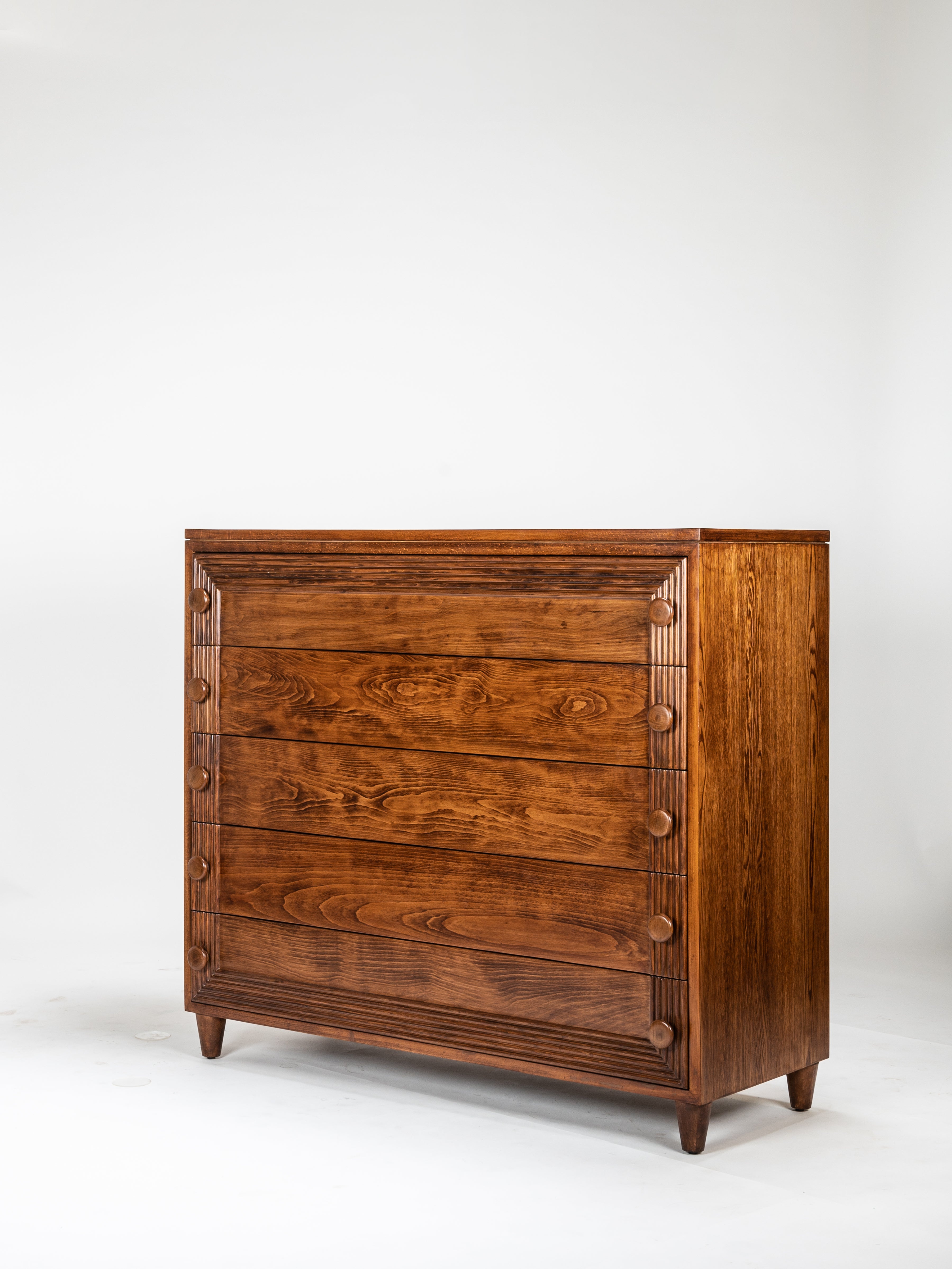 Wooden dresser with a warm brown finish on a white background