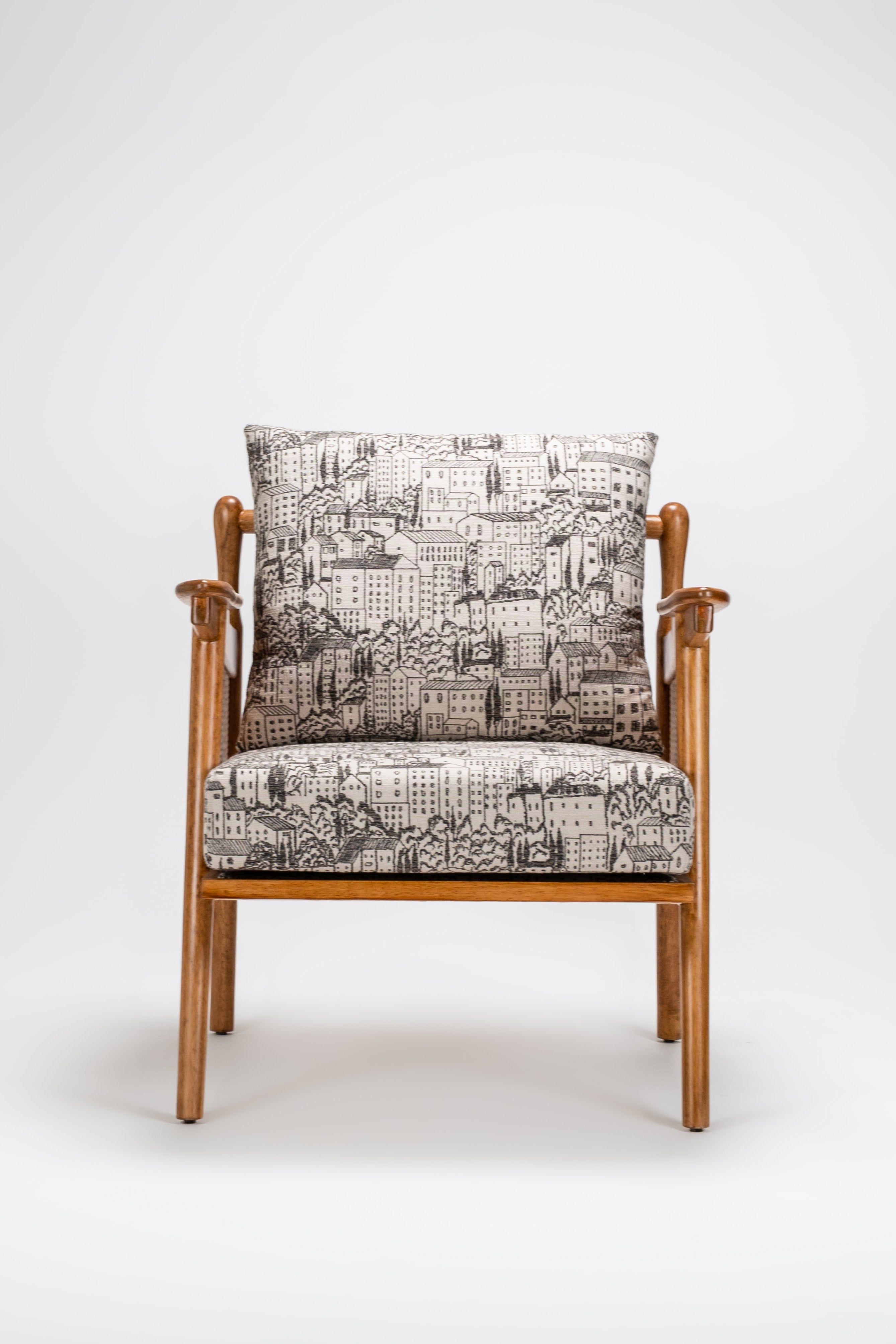 Wooden armchair with patterned cushion on a white background