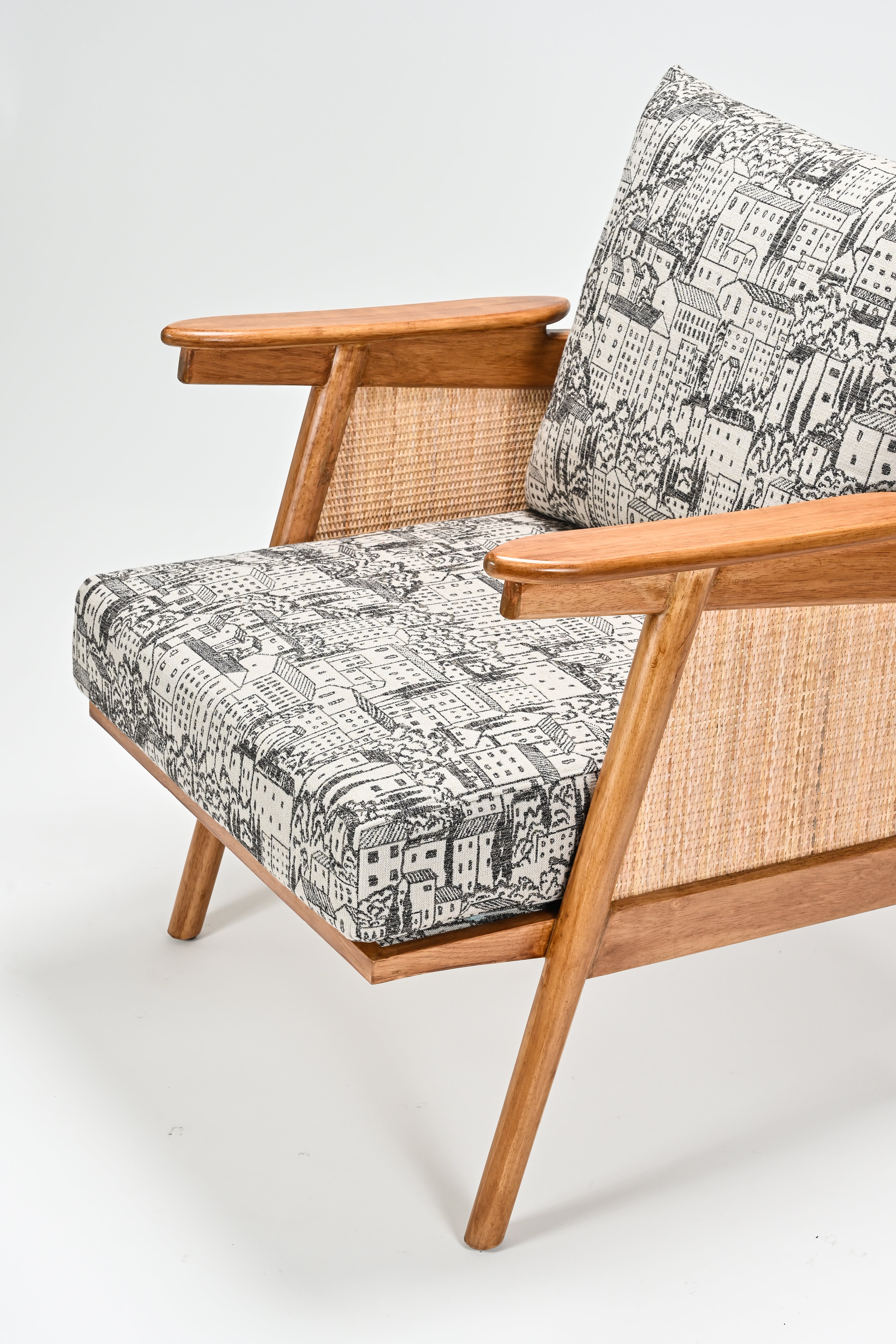 Wooden armchair with patterned cushions on a white background