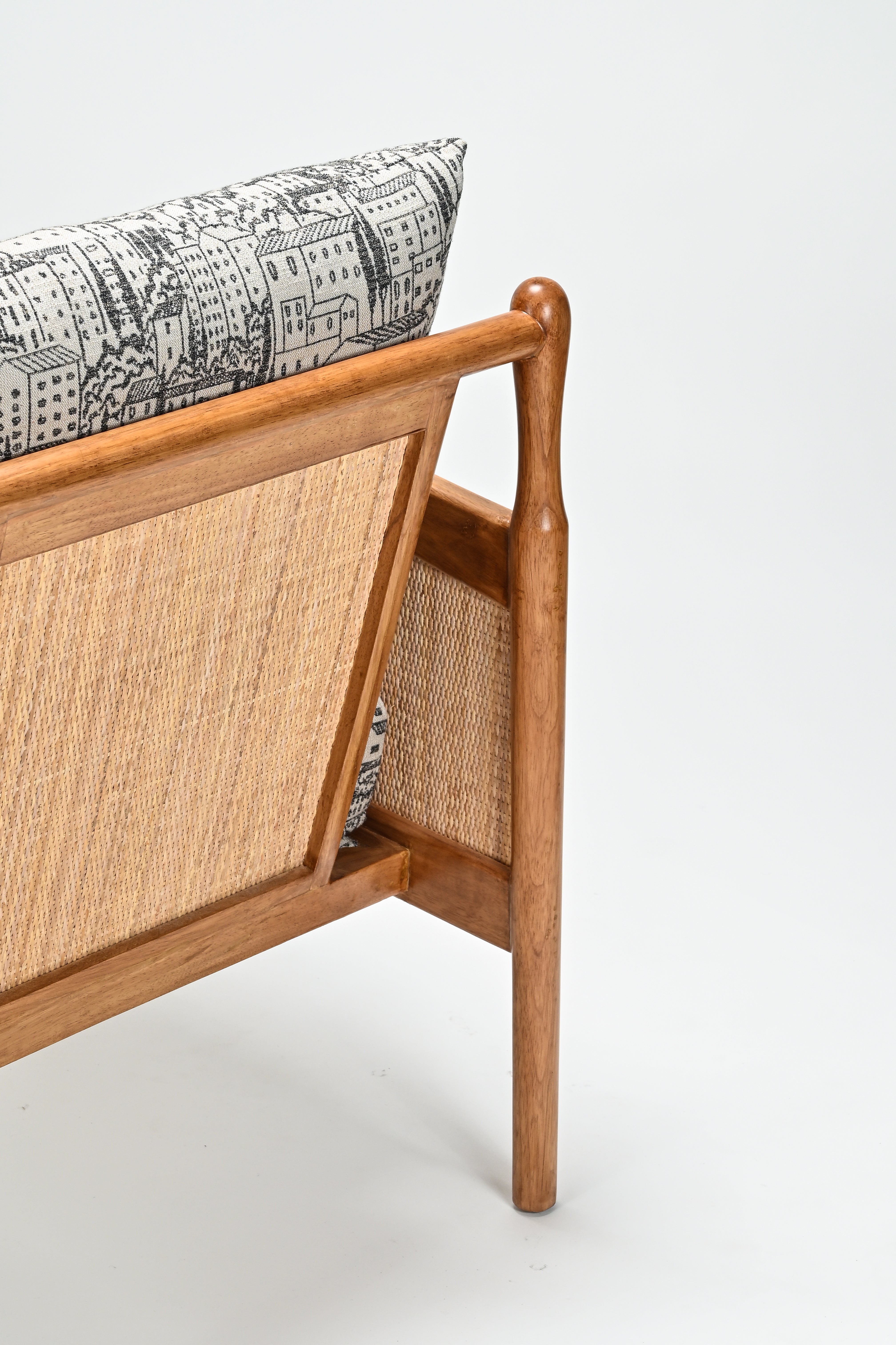 Wooden headboard with wicker panel and patterned cushion on a white background
