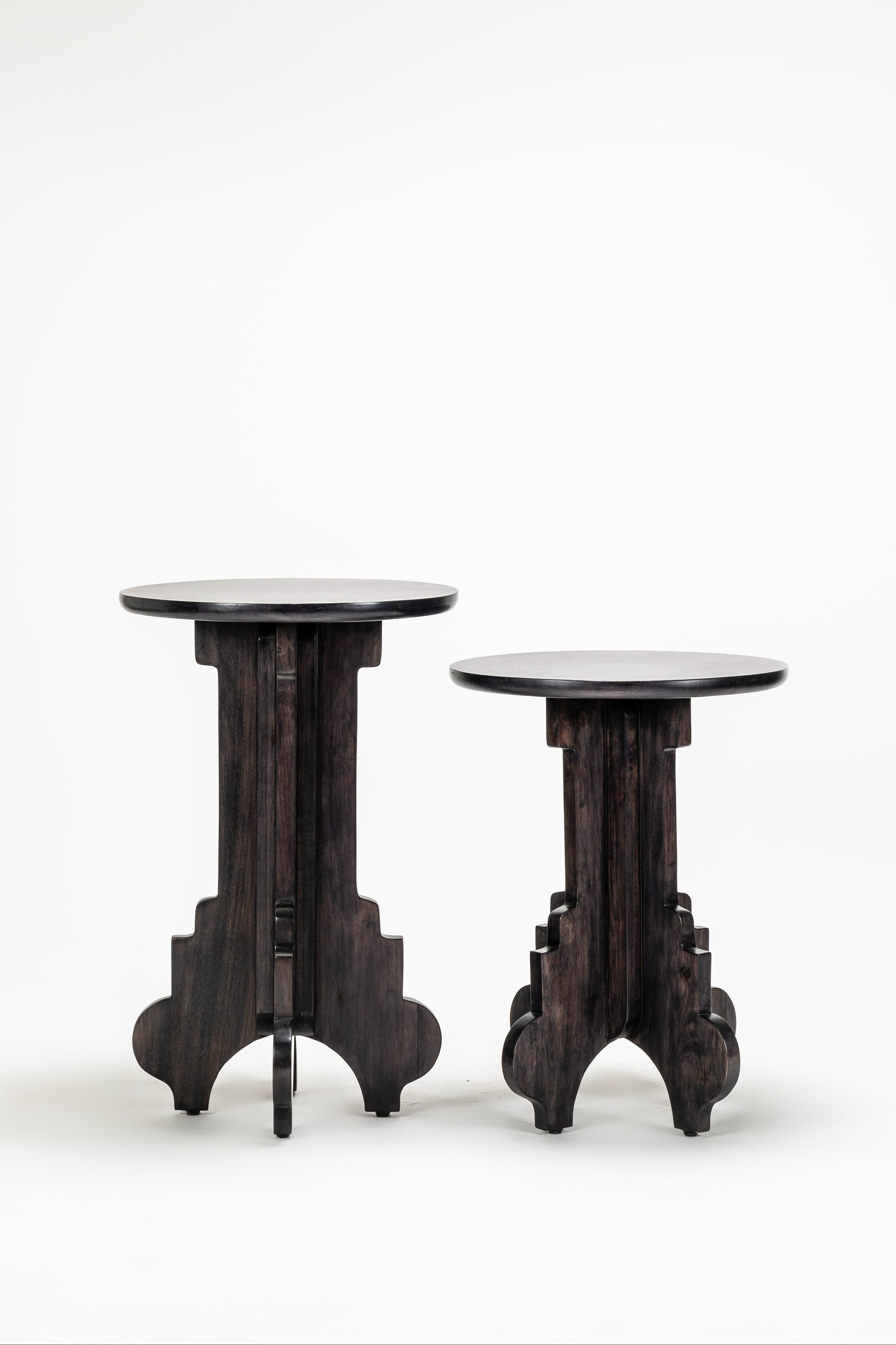 Two dark wooden side tables on a white background