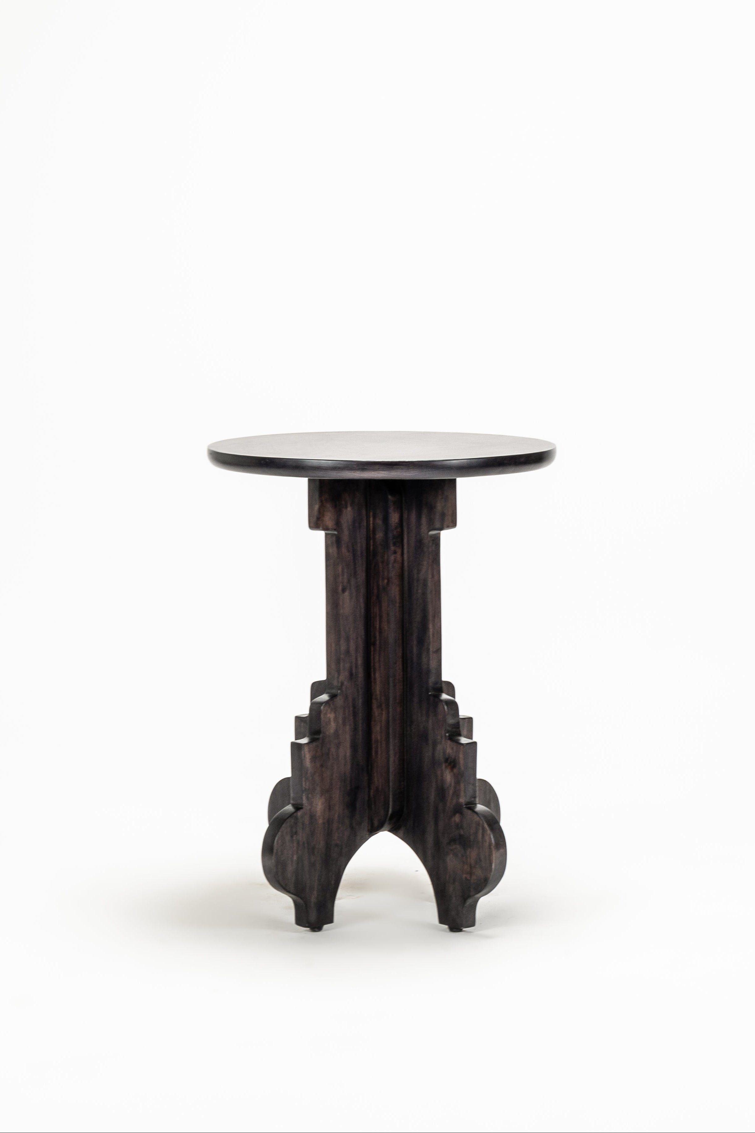 Small round table with a black base on a white background