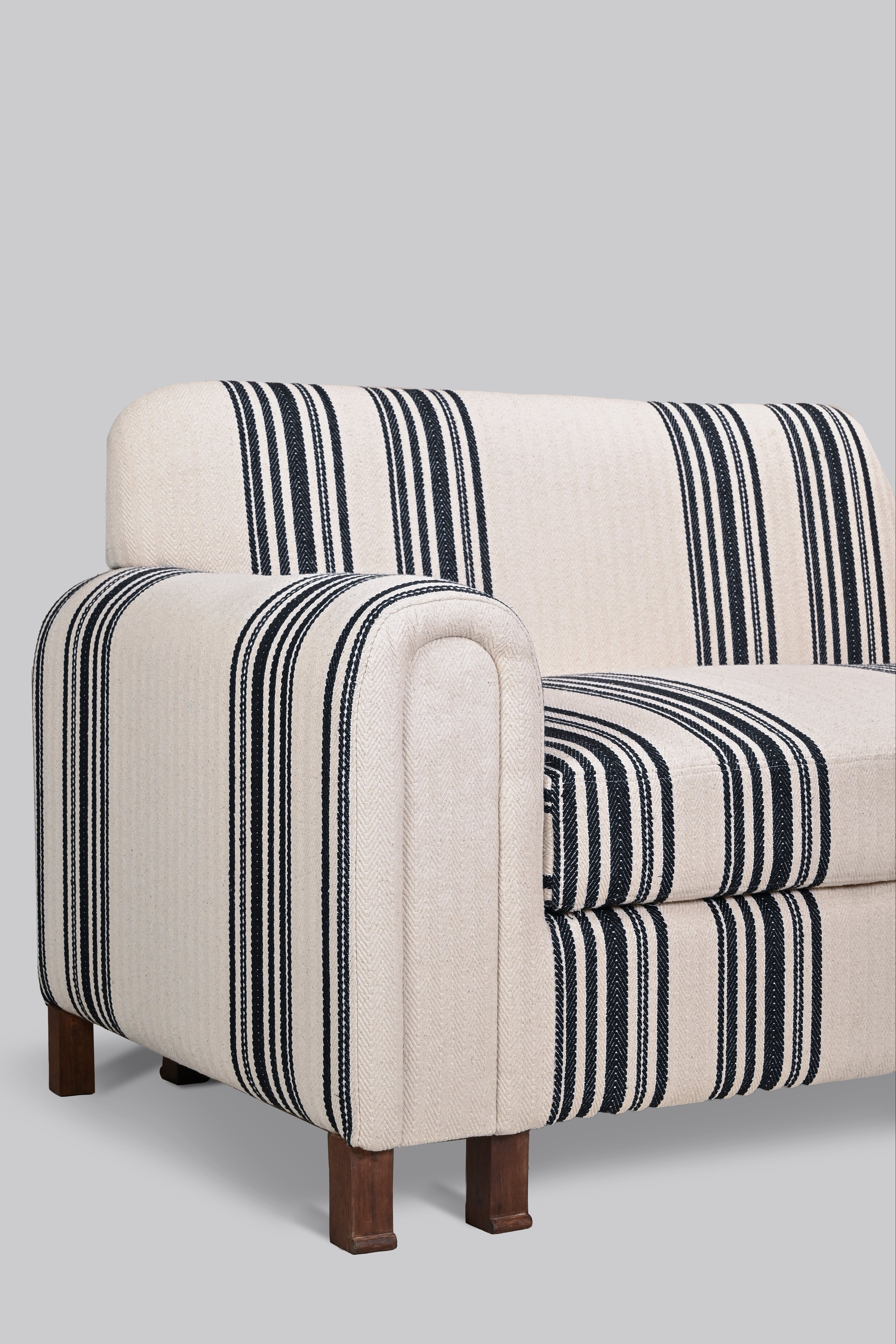 Striped sofa with black and white pattern on a gray background