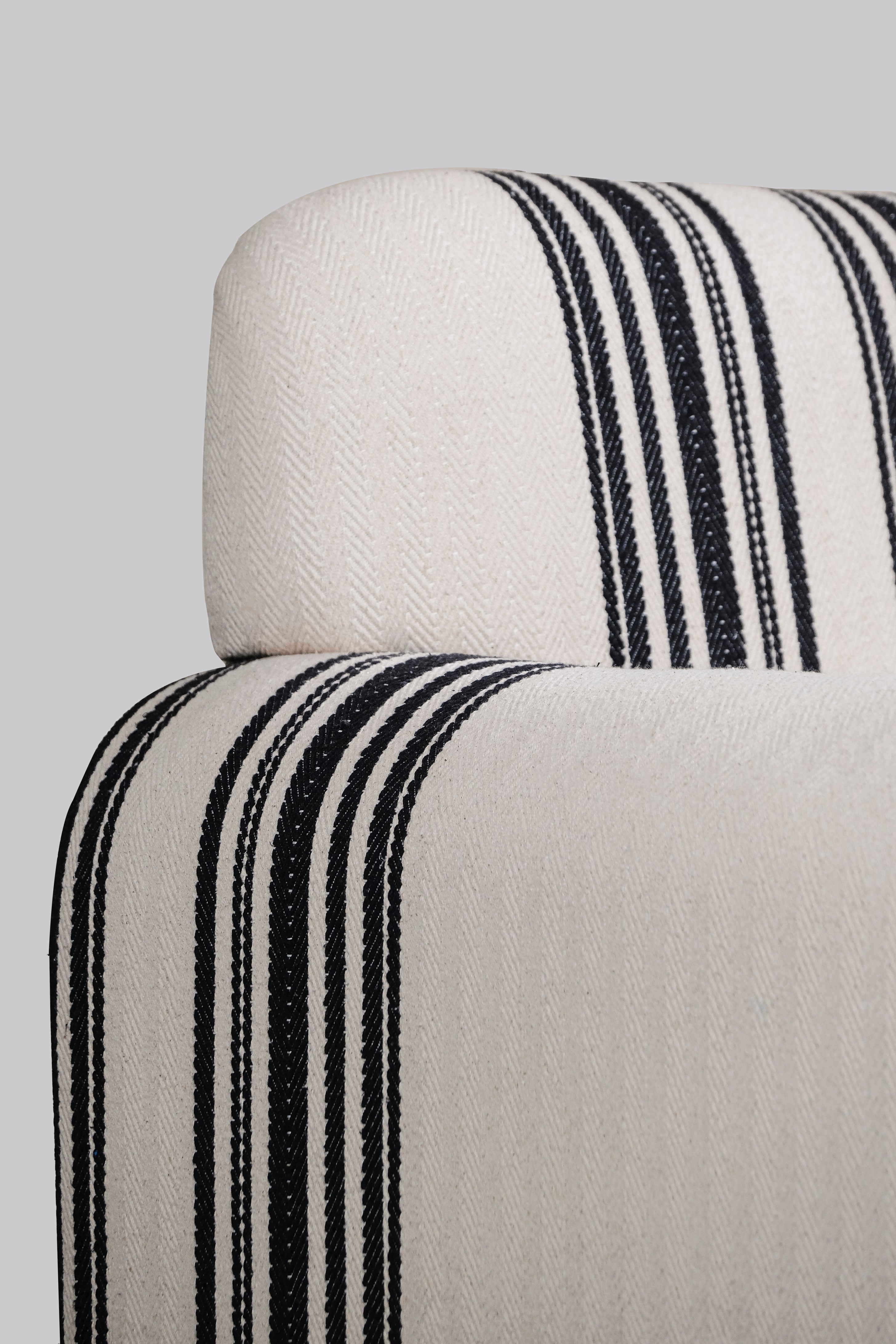 Close-up of a chair with black striped pattern on a gray background