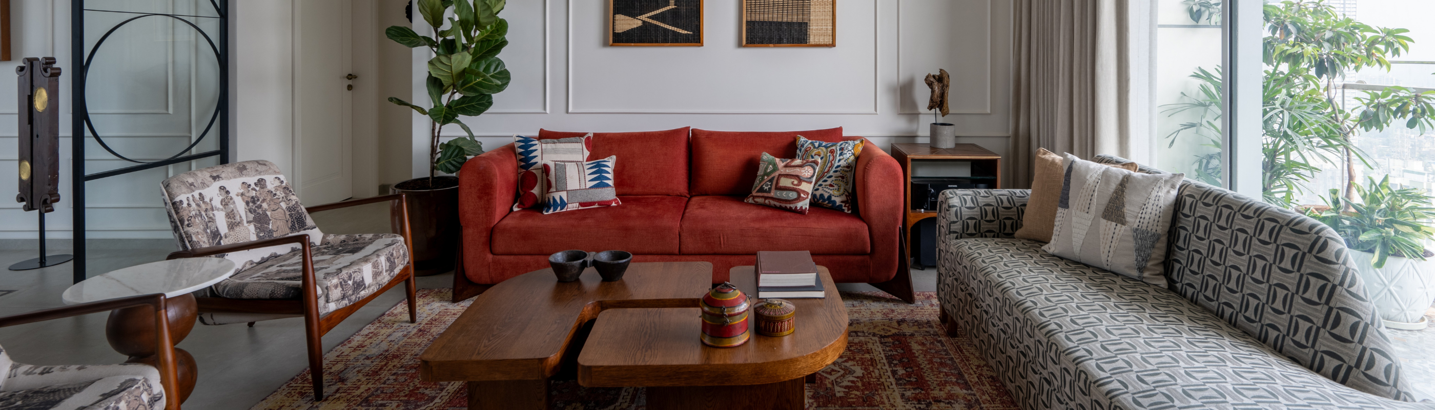 Living room with red sofa, patterned chairs, and a coffee table.