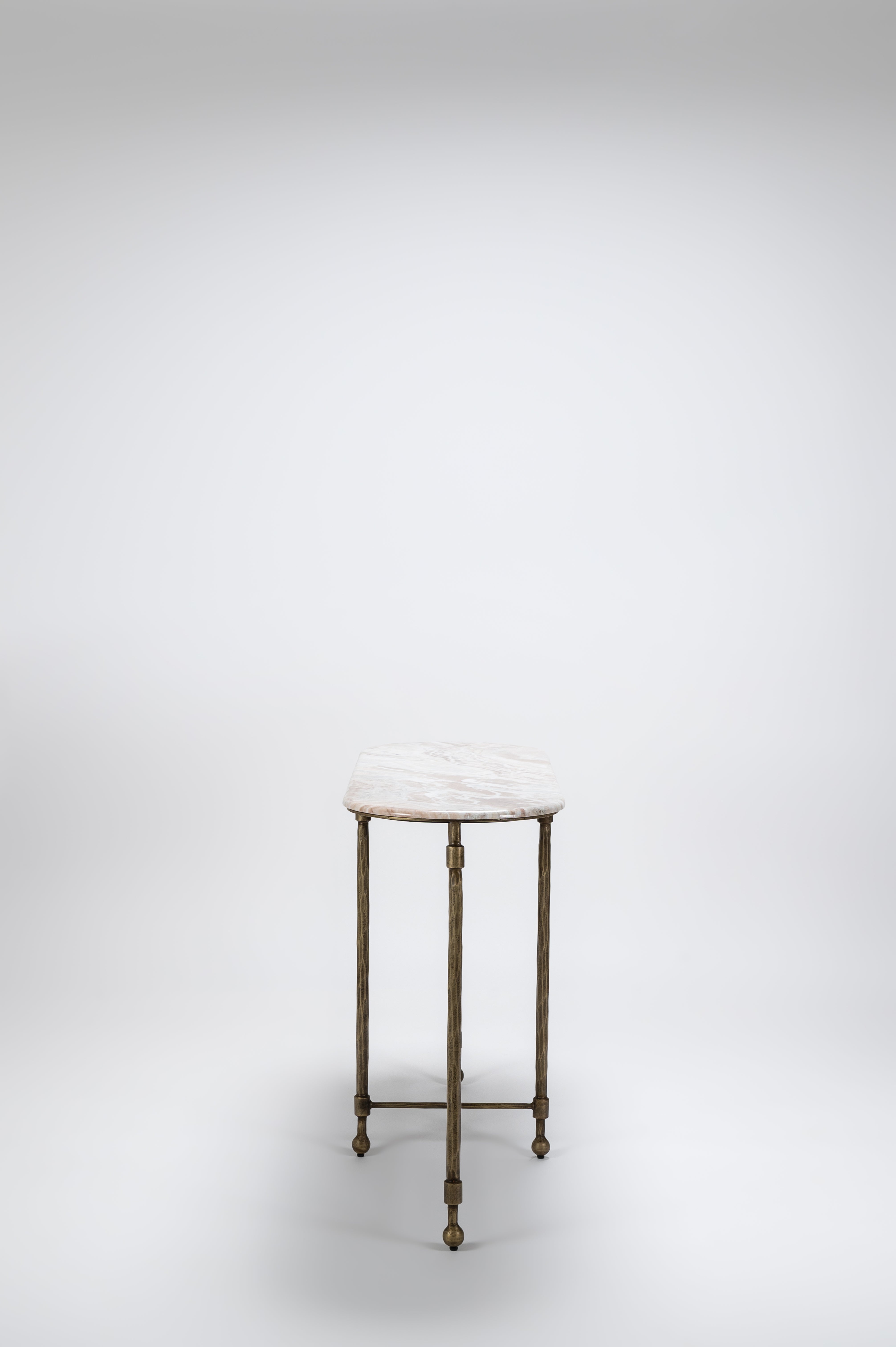 Small round table with marble top and brass legs on a white background