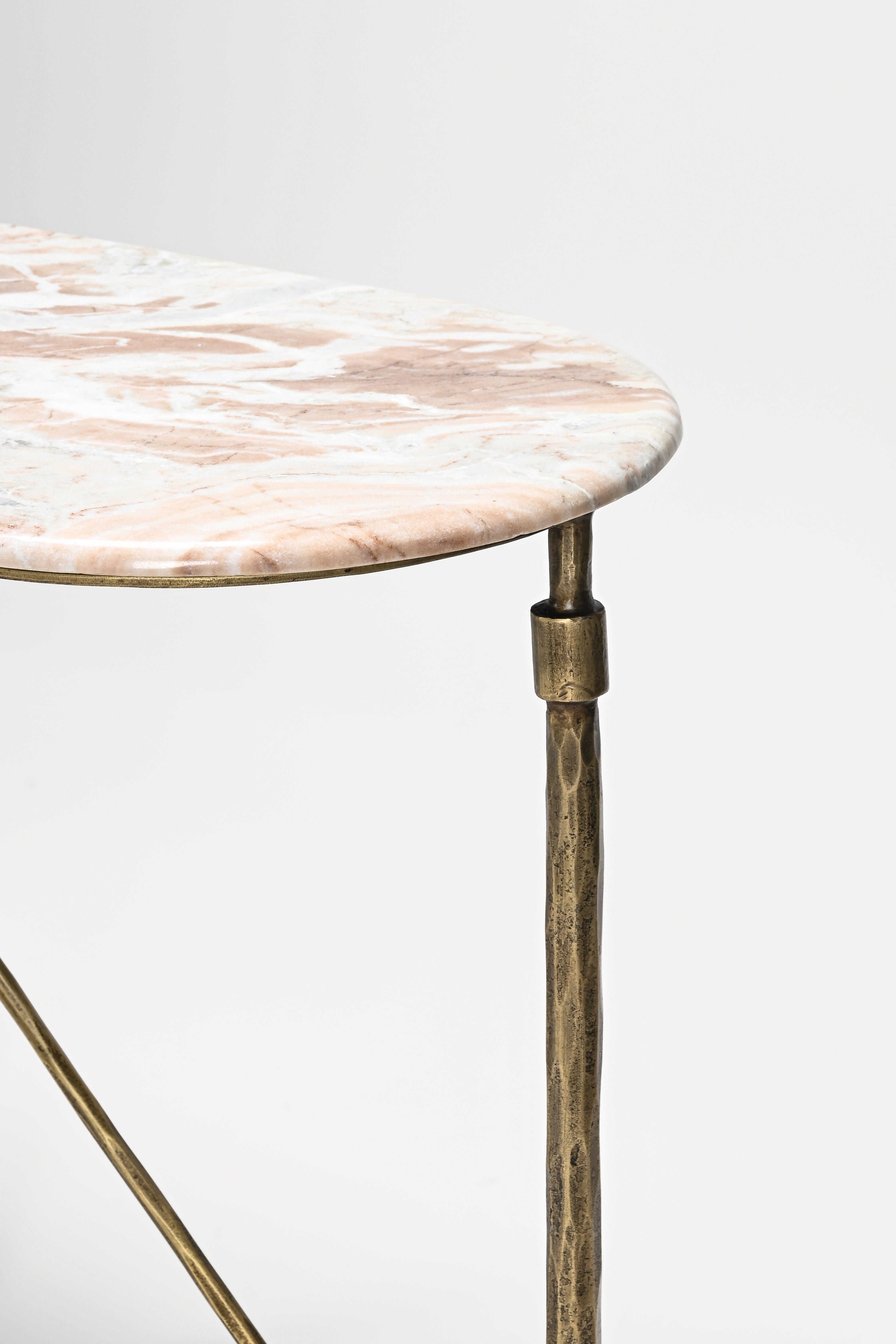 Round marble table with brass legs on a white background
