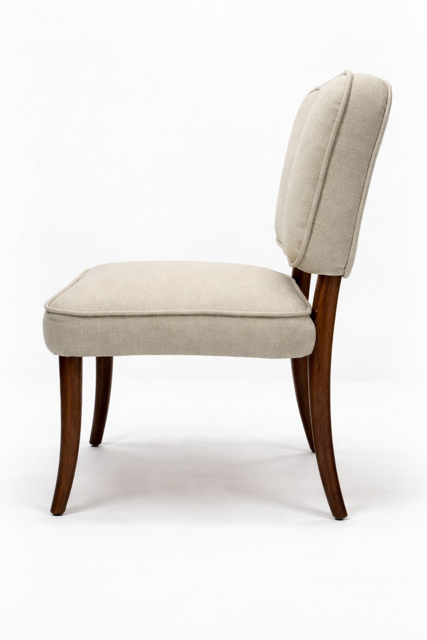 Beige upholstered chair with wooden legs on a white background