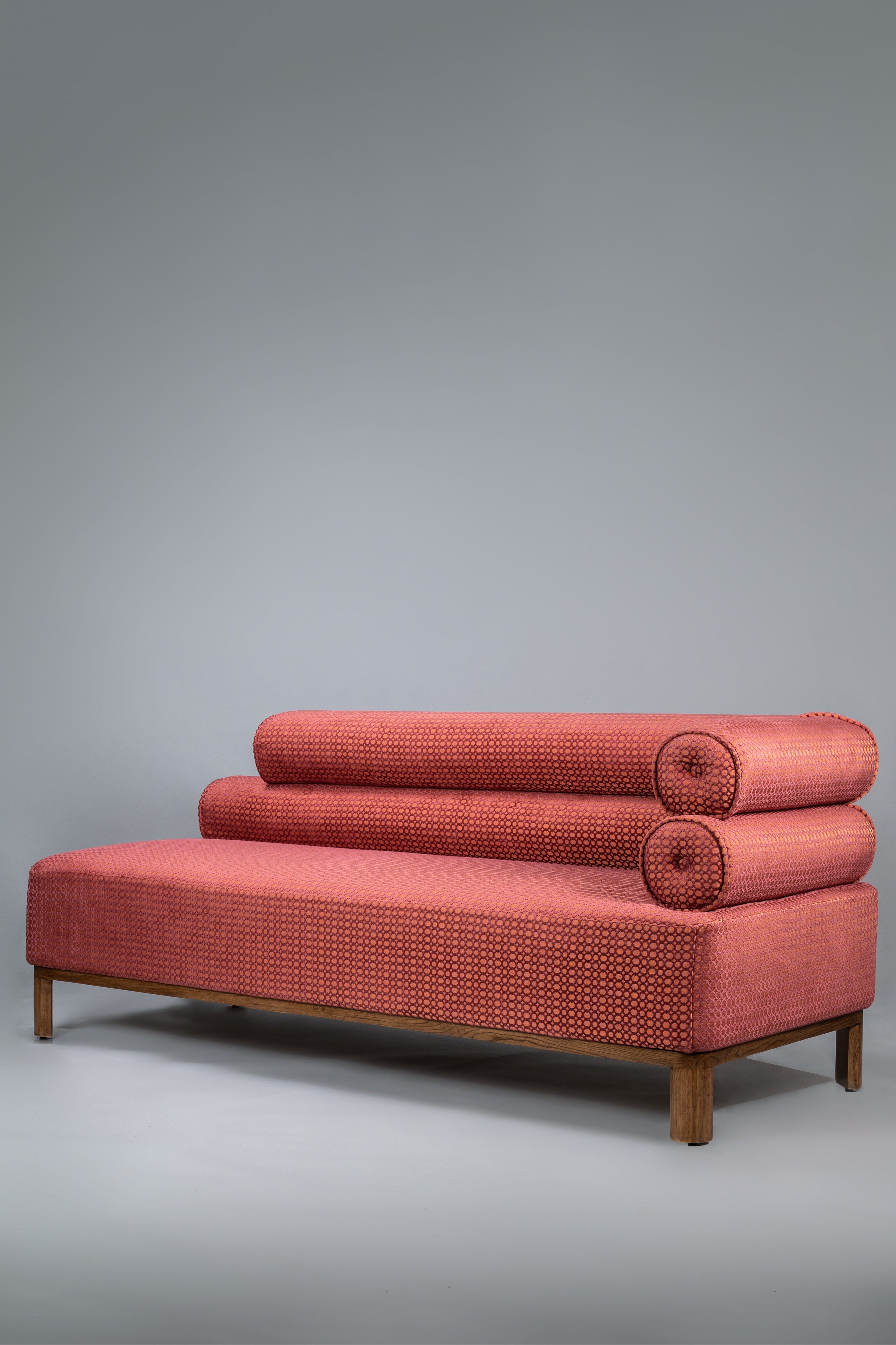 Red sofa with a textured pattern on a gray background