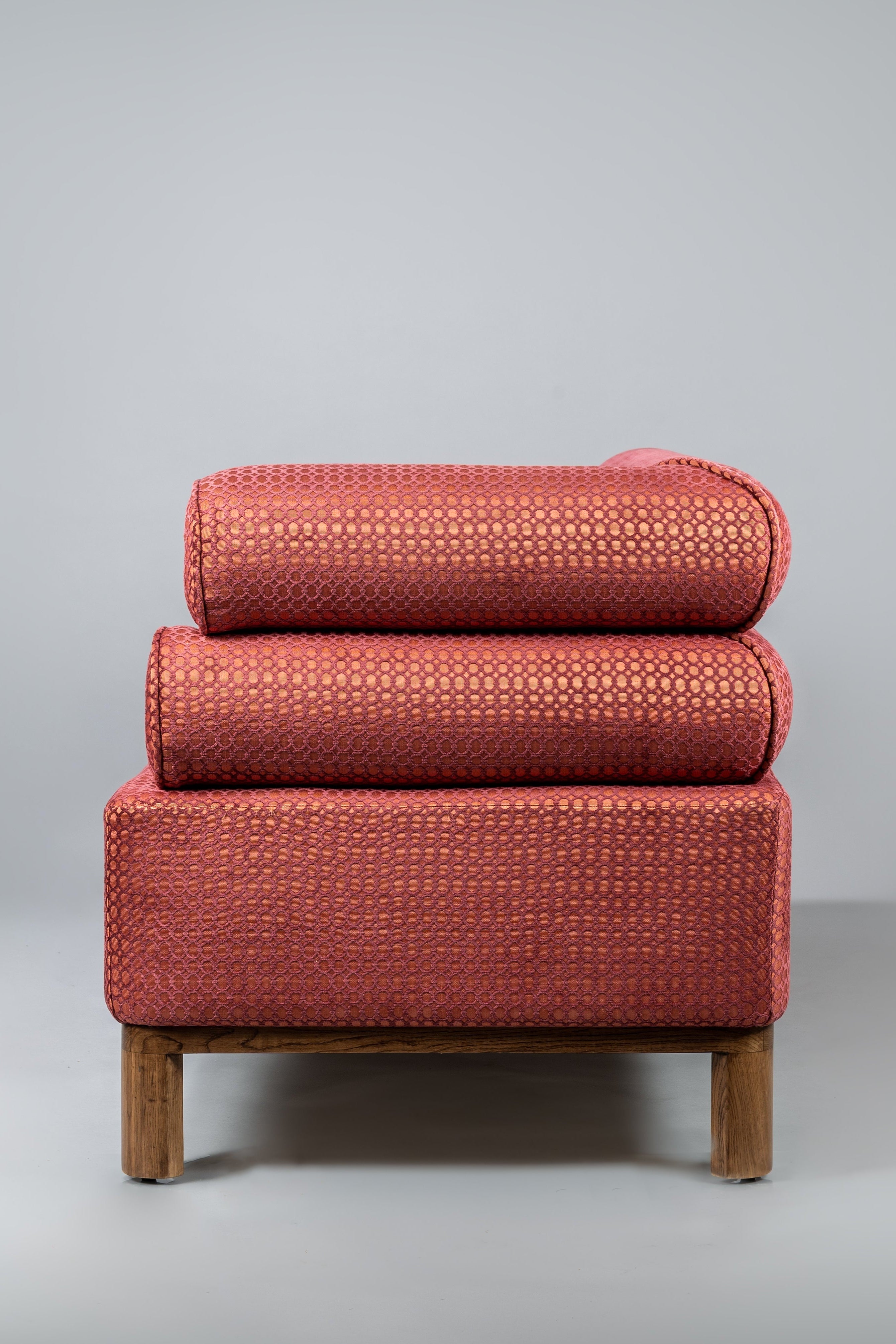 Red upholstered chair on a gray background