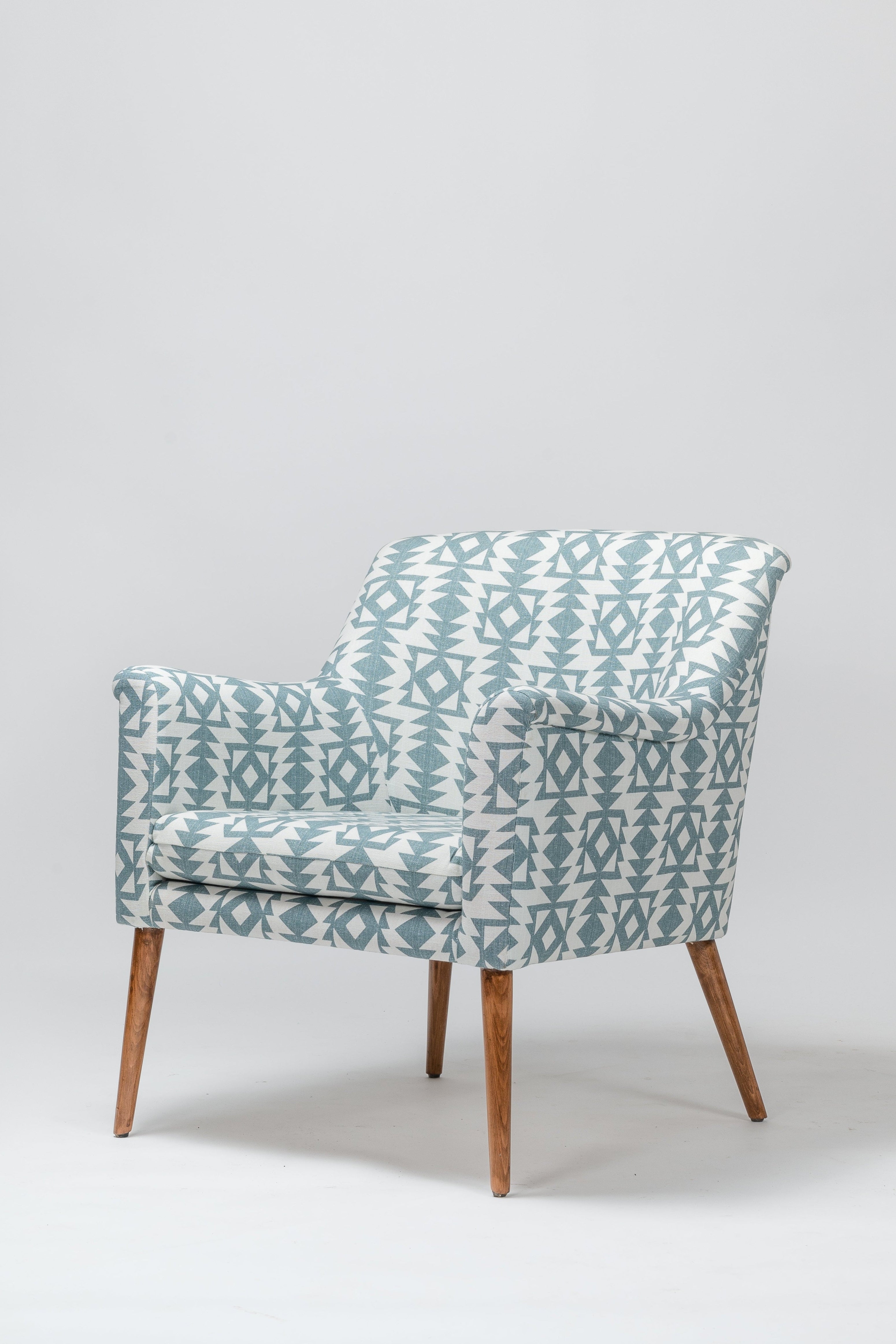 Patterned armchair with wooden legs on a white background