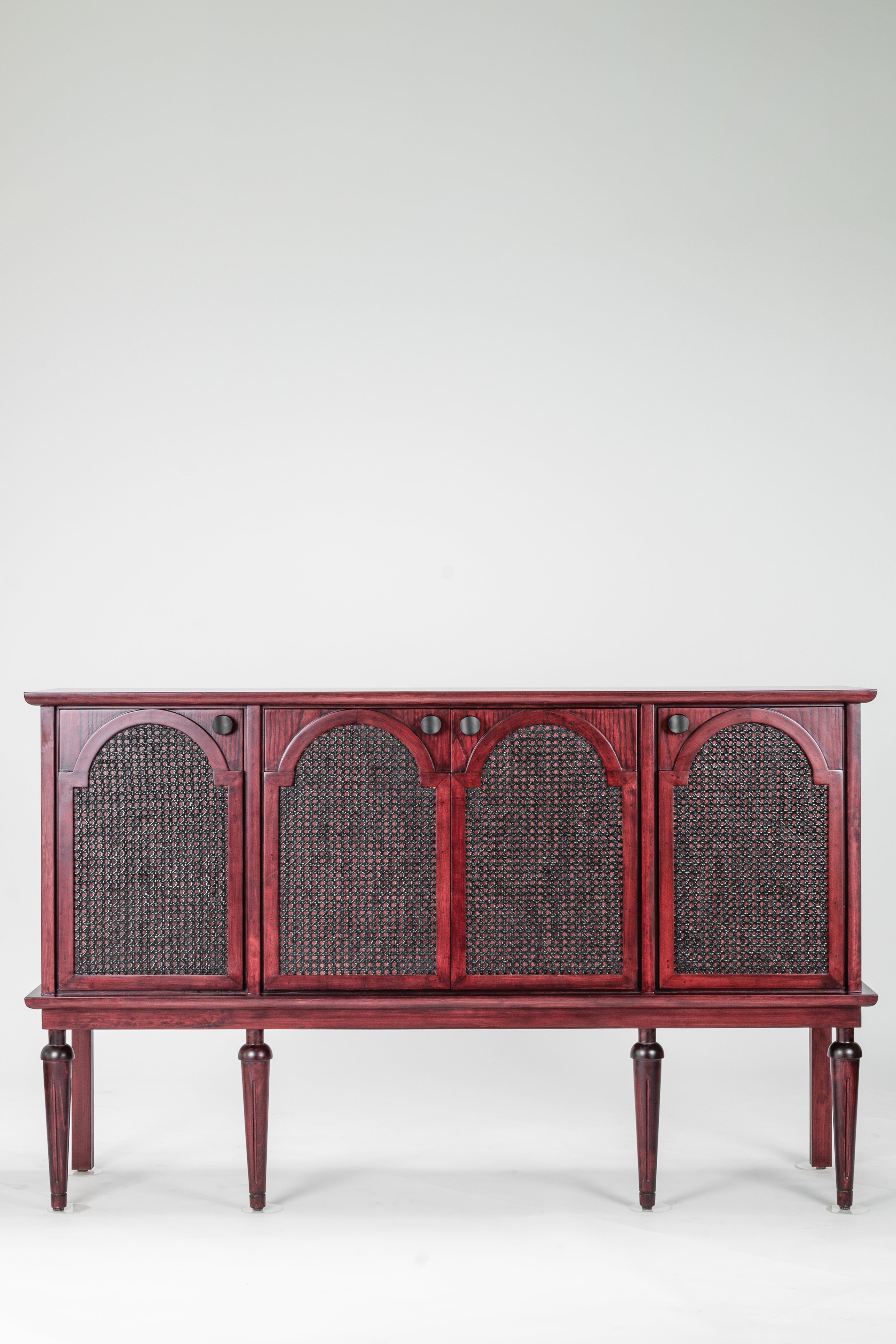 Red wooden sideboard with wicker panels on a white background