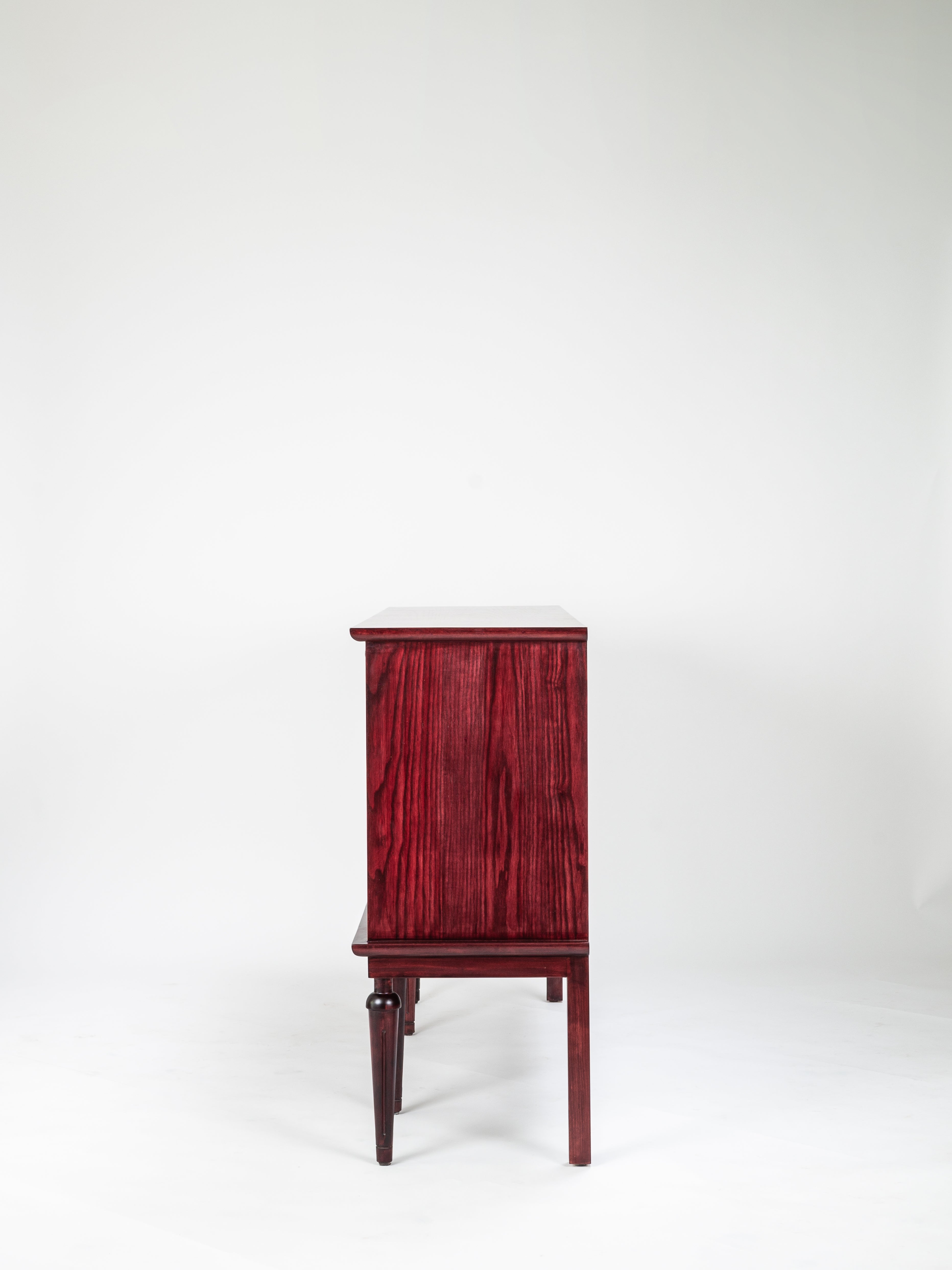 Wooden cabinet with a red-brown finish on a white background