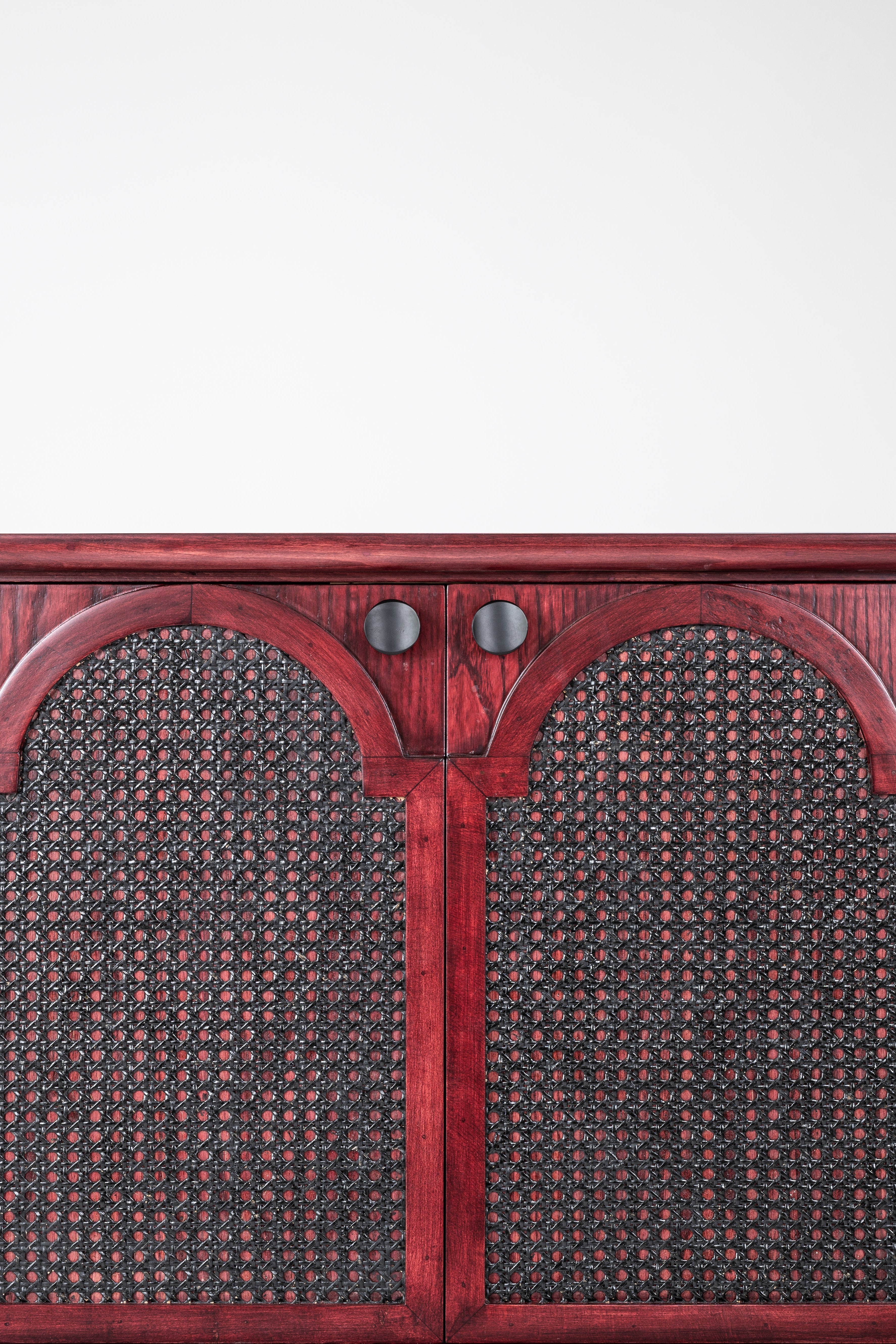Wooden cabinet with wicker door panels on a white background