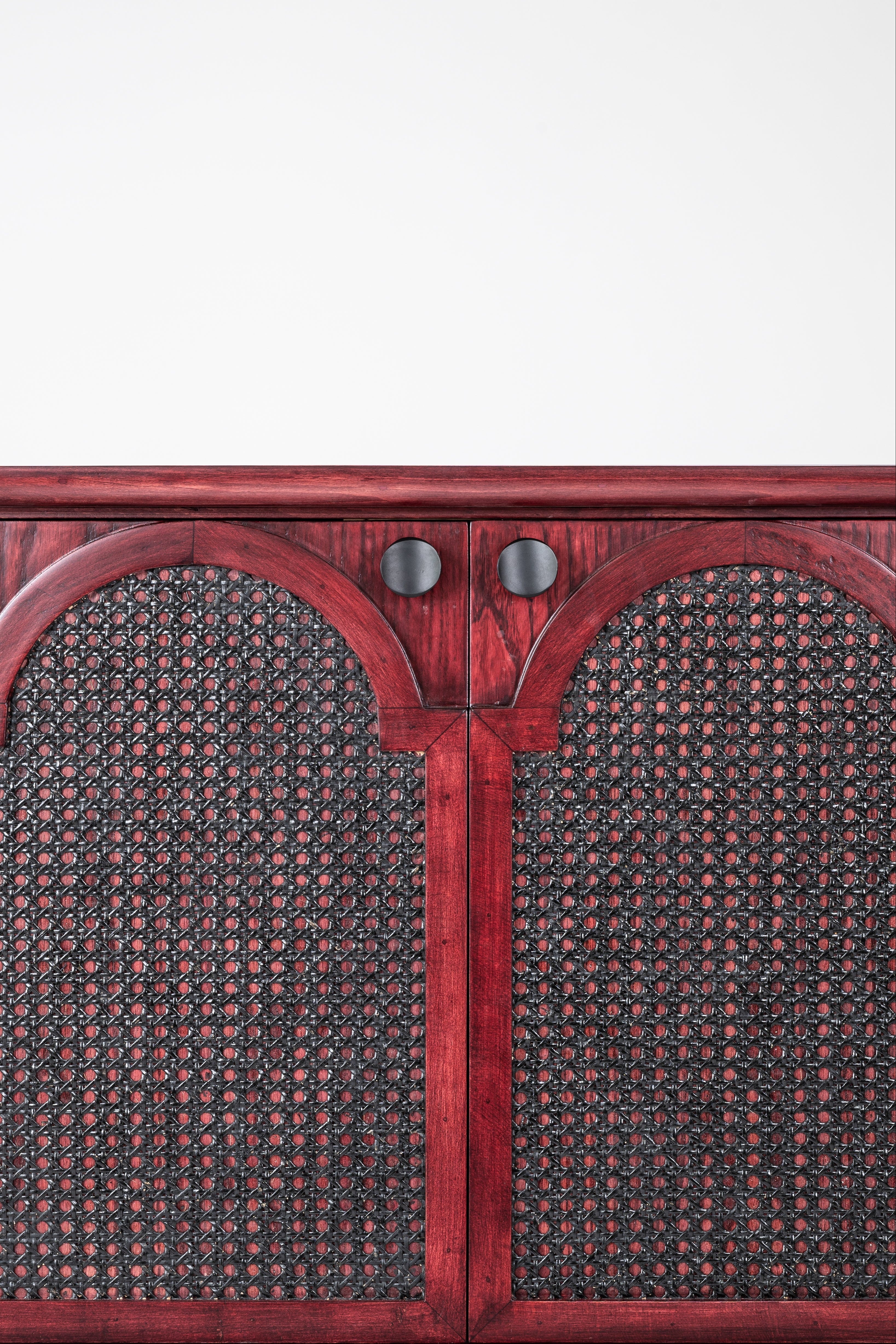 Wooden cabinet with wicker door panels on a white background