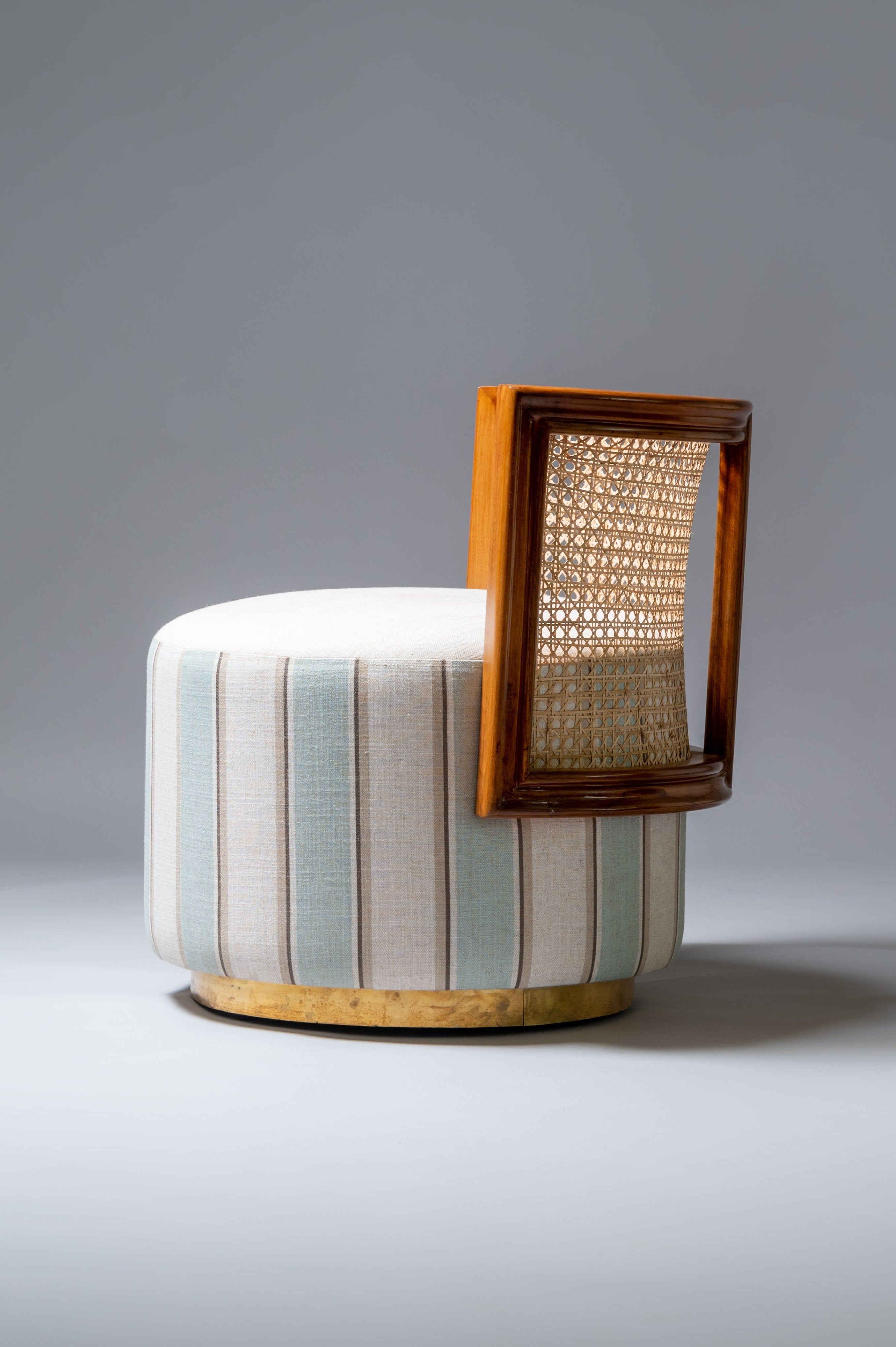 Decorative stool with striped design and wooden frame on a gray background
