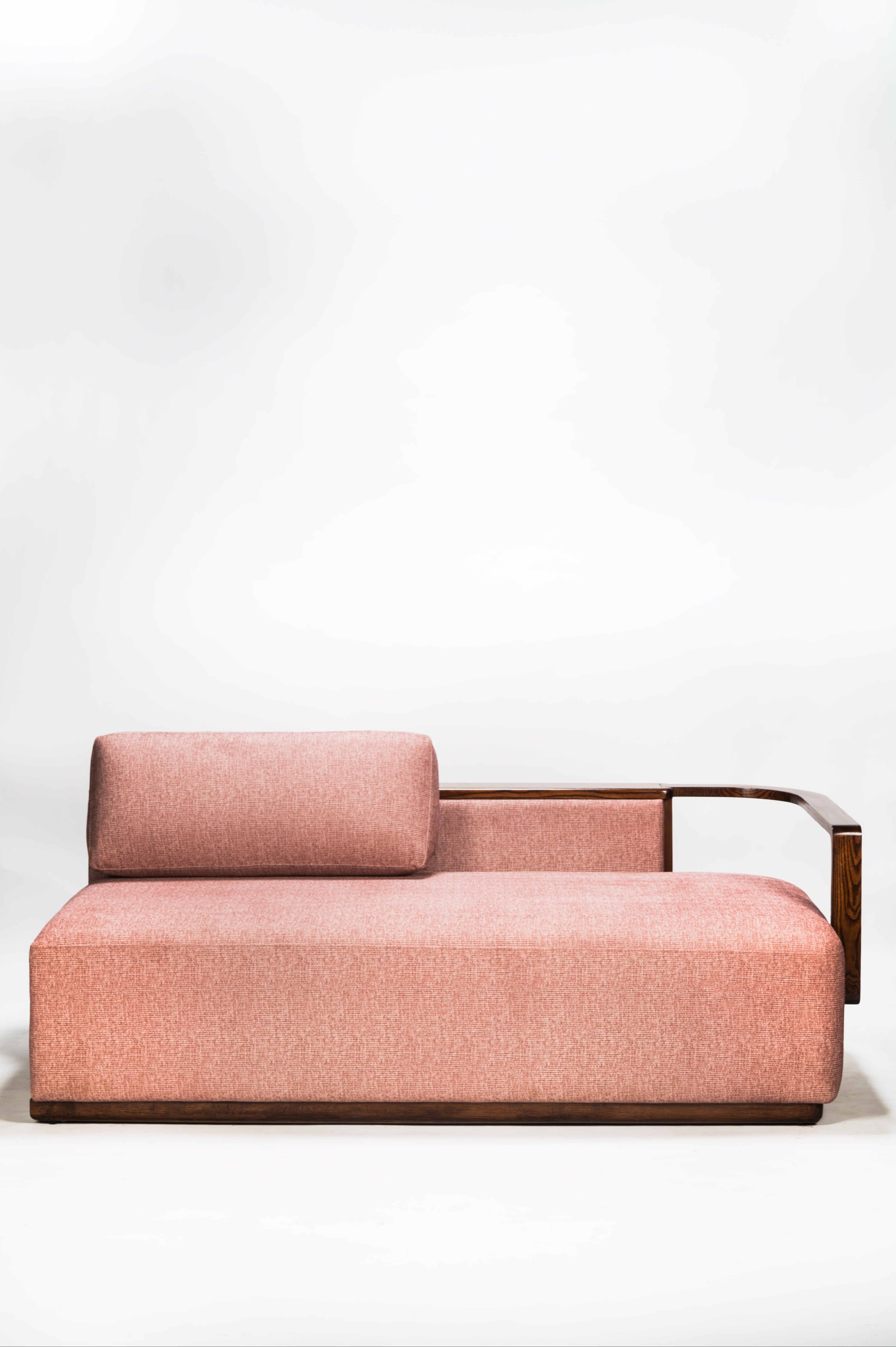 Pink sofa with wooden frame on a white background