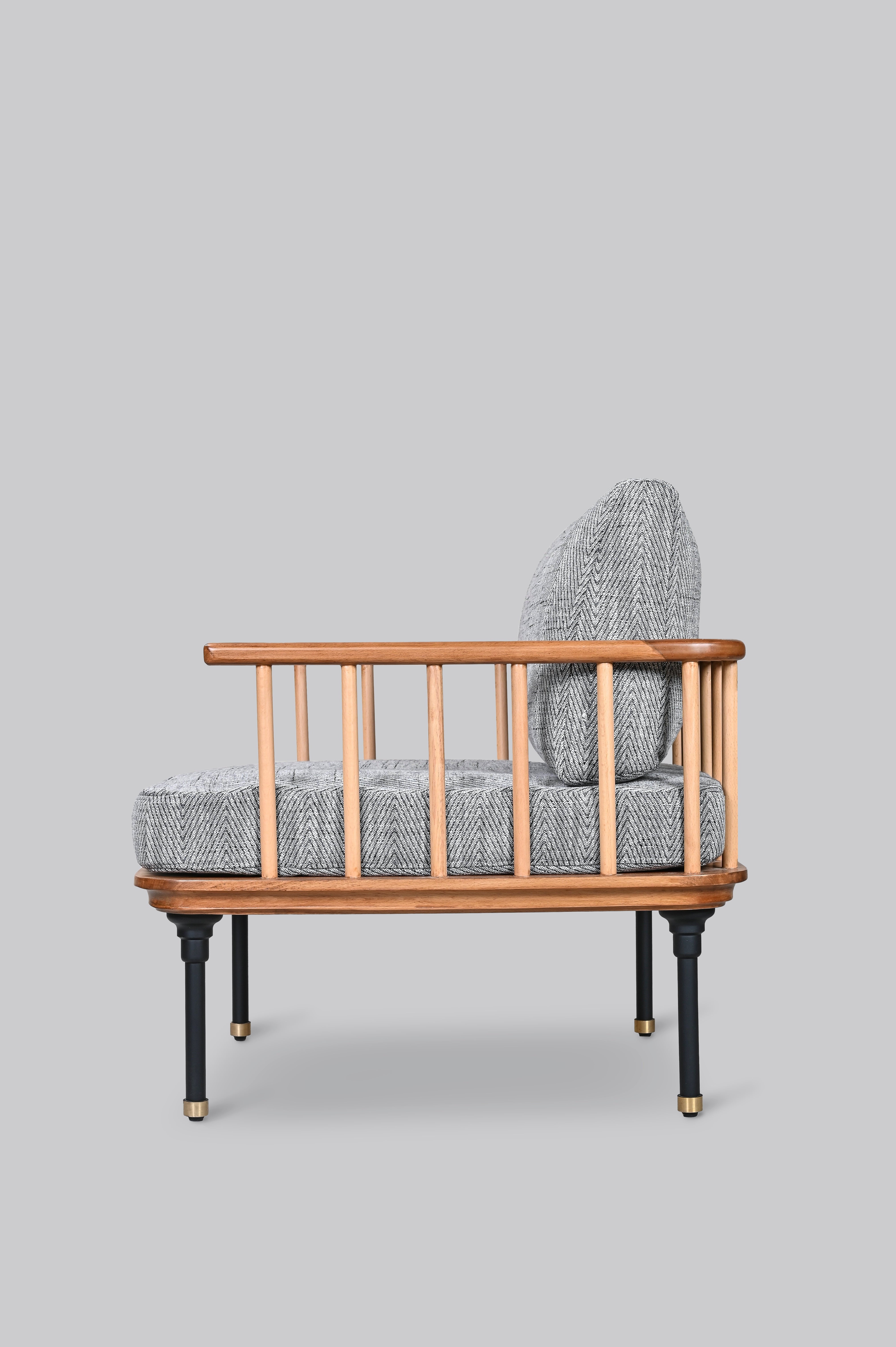 Wooden armchair with gray cushioned backrest and seat on a light gray background