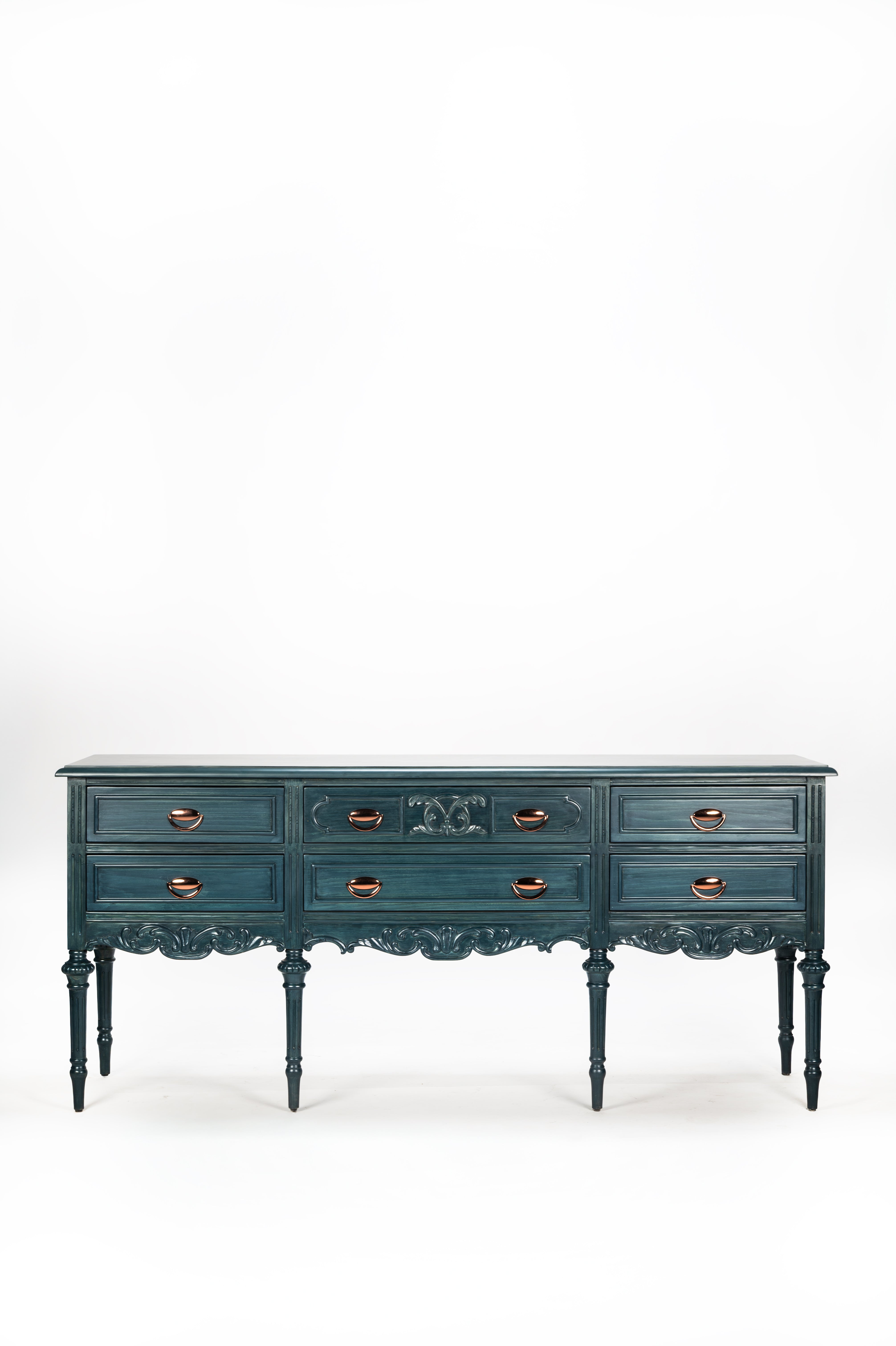 Blue dresser with decorative carvings on a white background