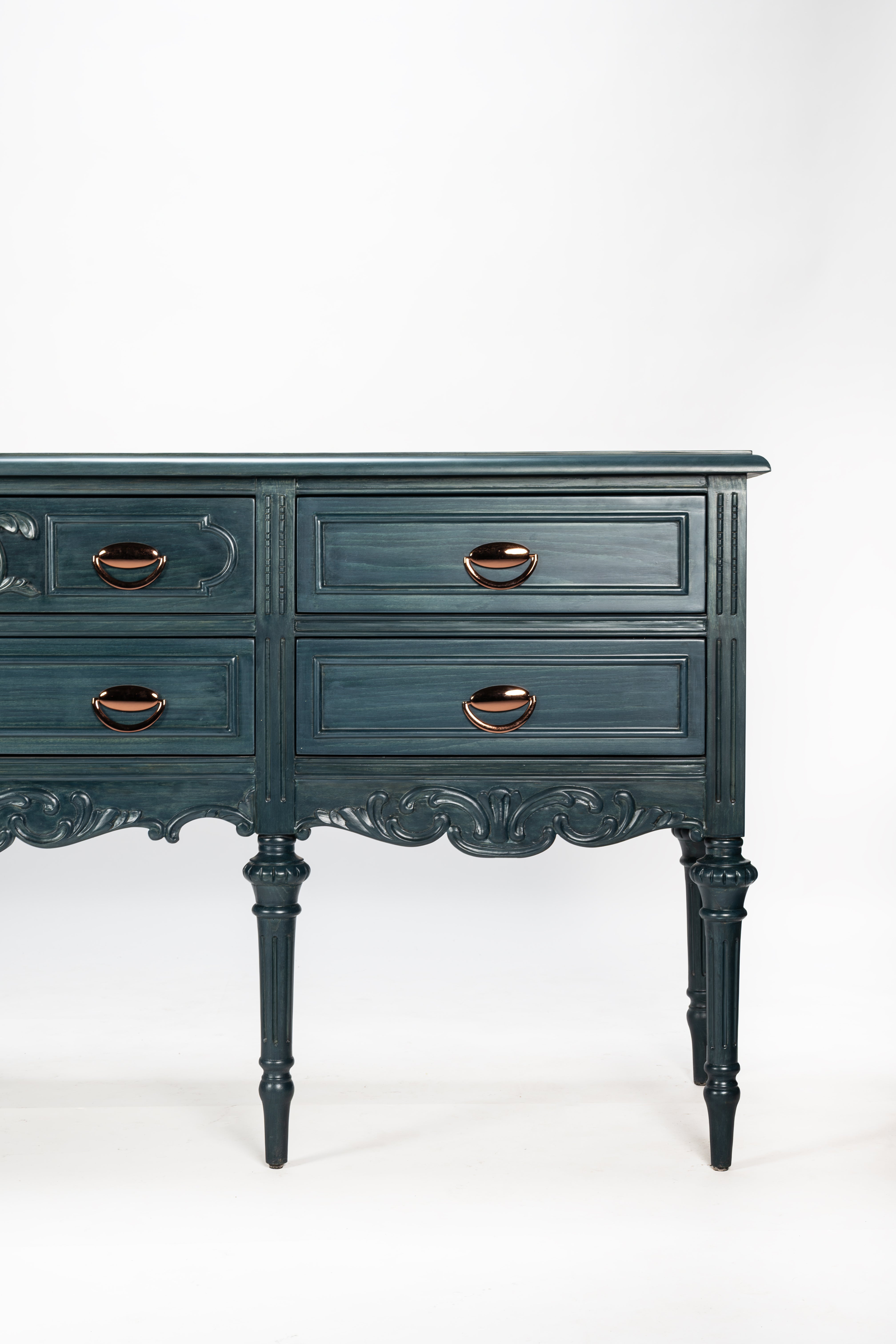 Dark blue vintage-style dresser with brass handles on a white background