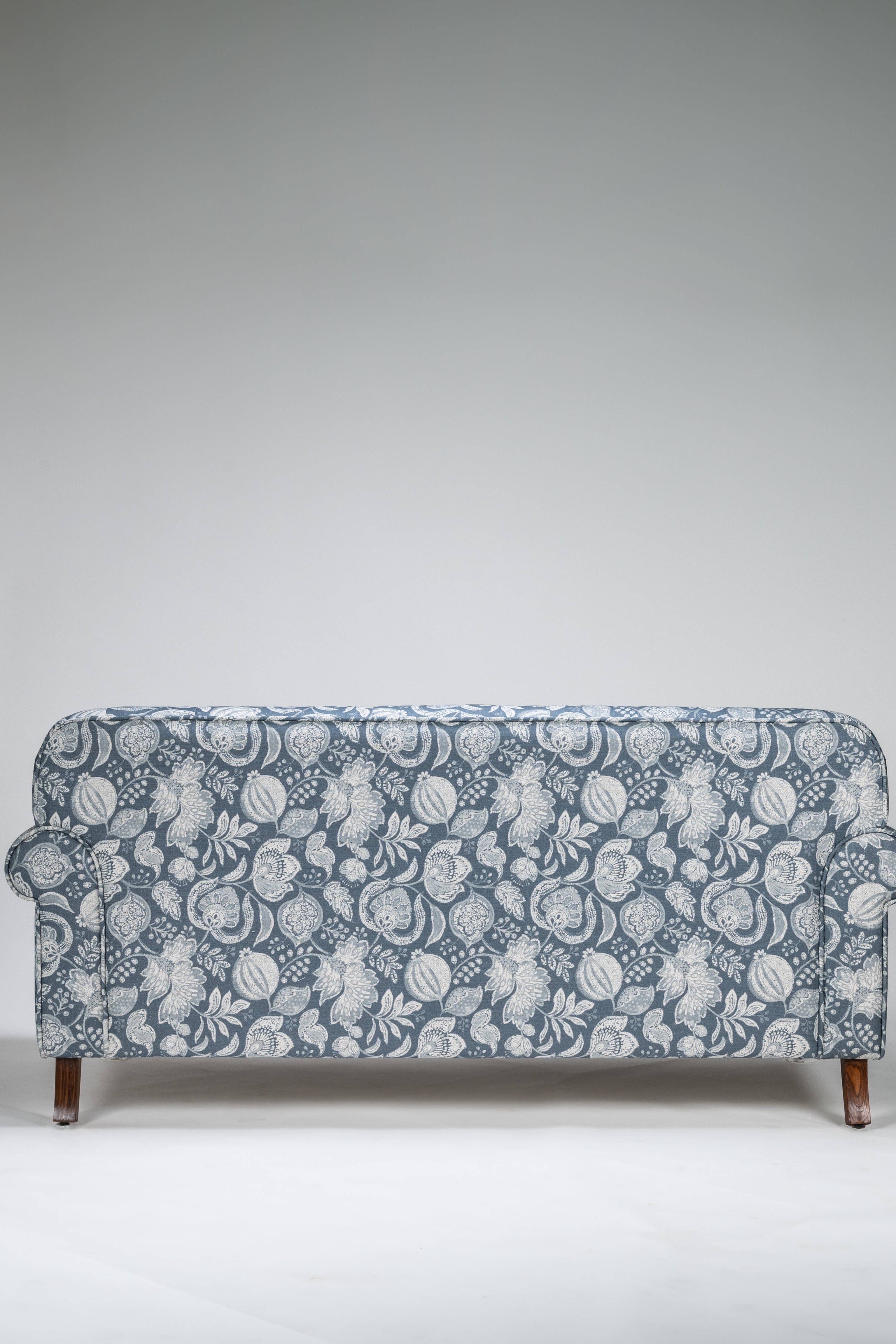 Floral patterned sofa on a plain background