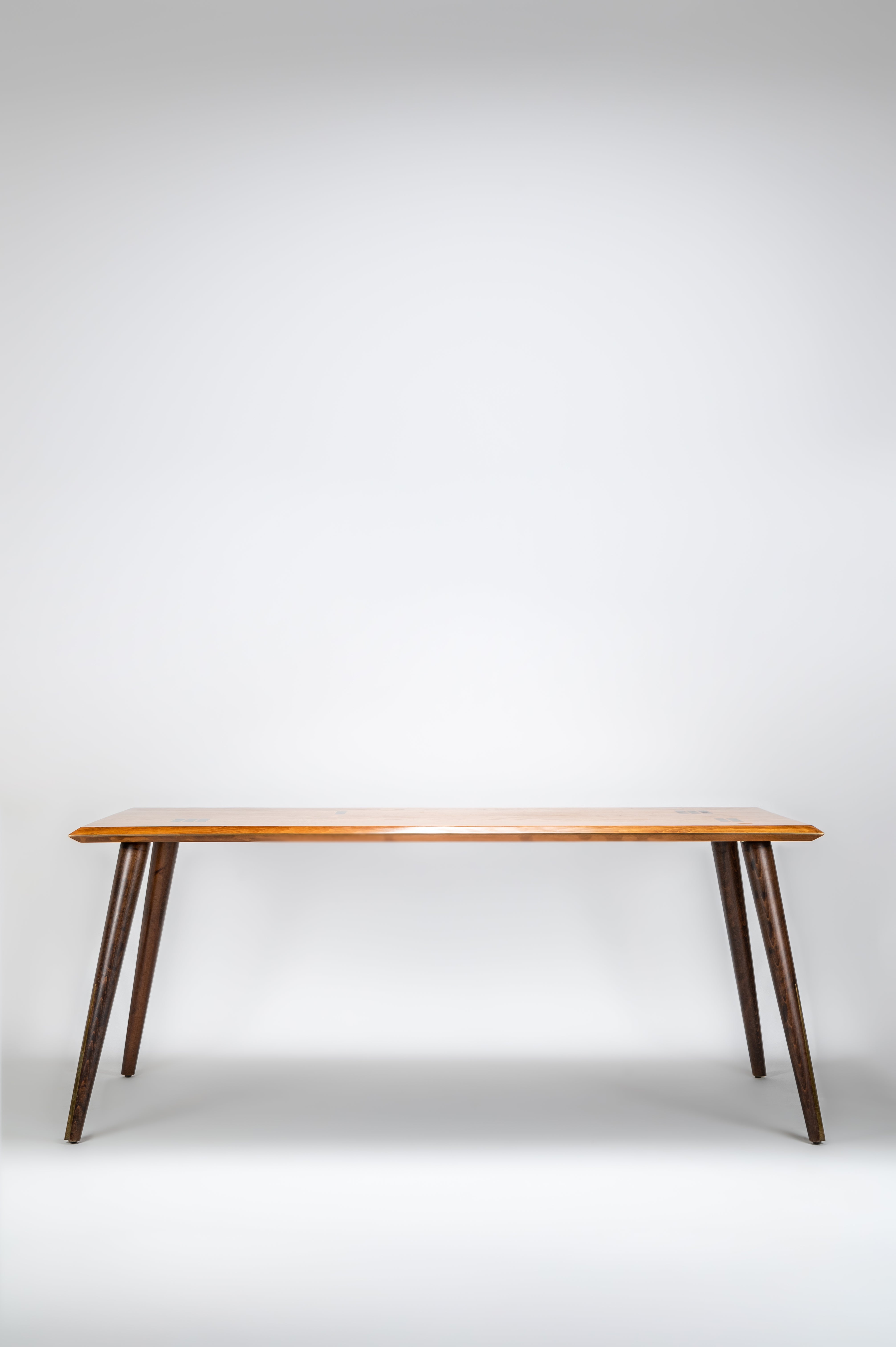 Wooden table with dark legs on a white background