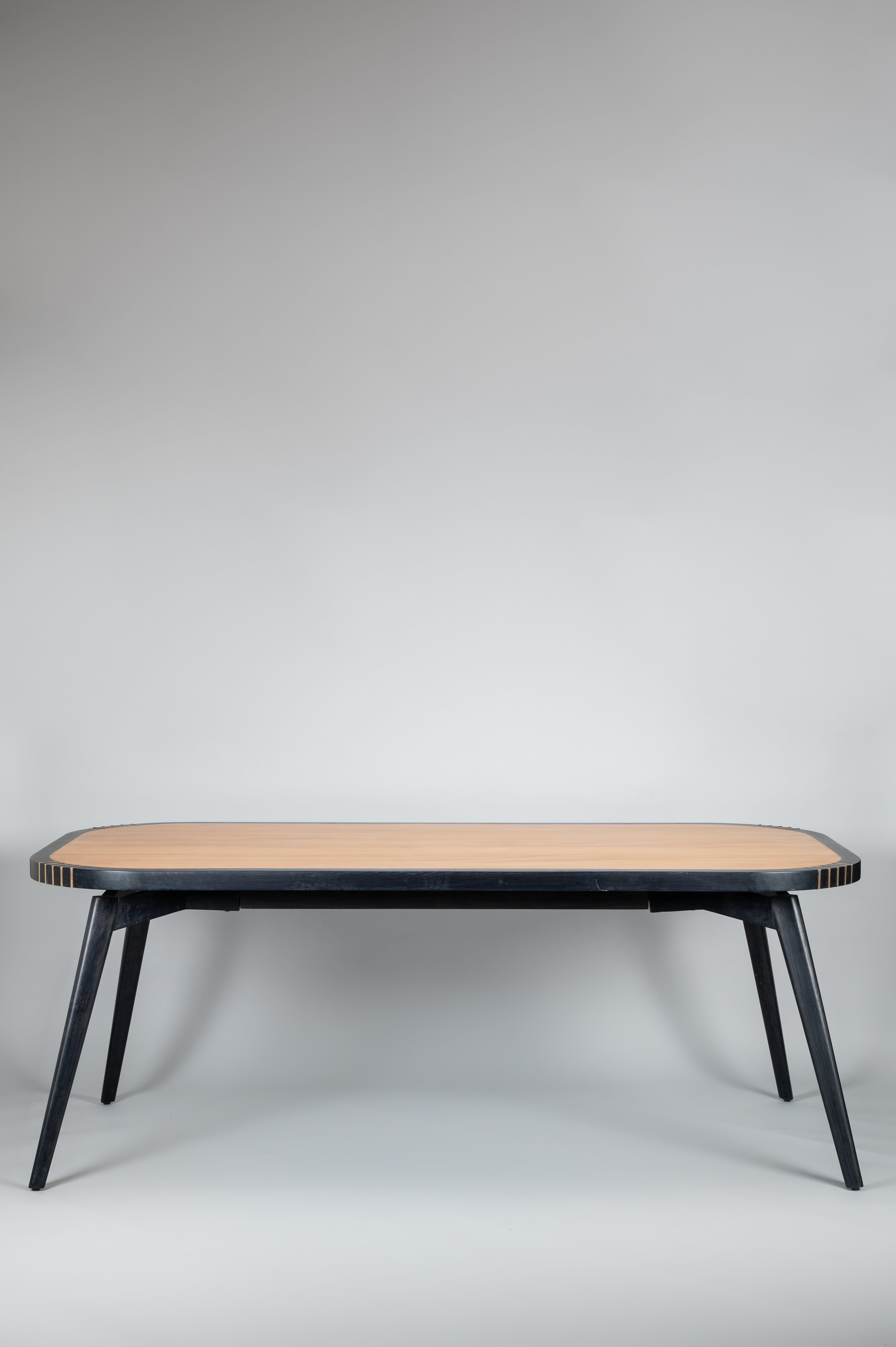 Wooden table with black legs on a gray background