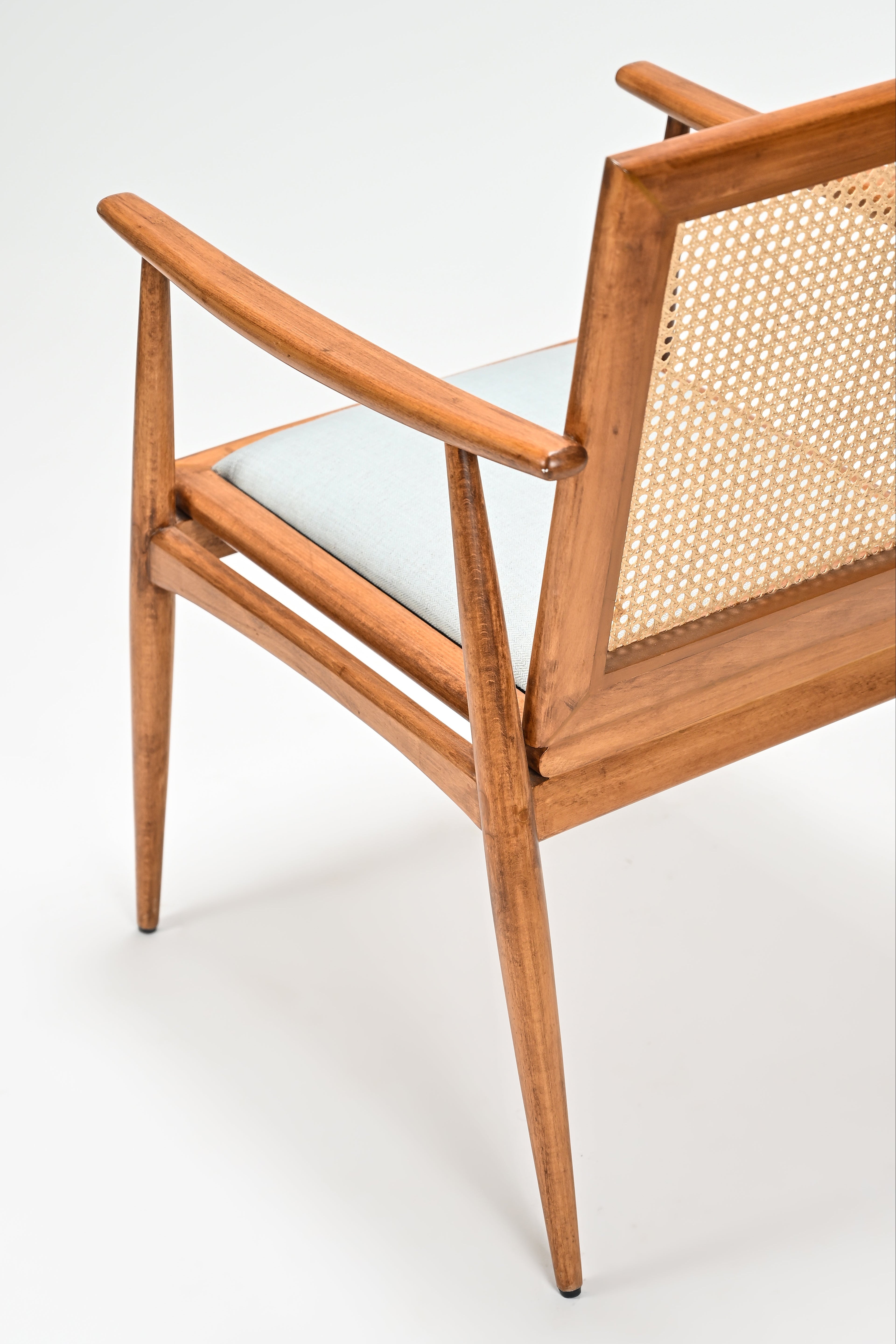Wooden chair with wicker backrest on a white background