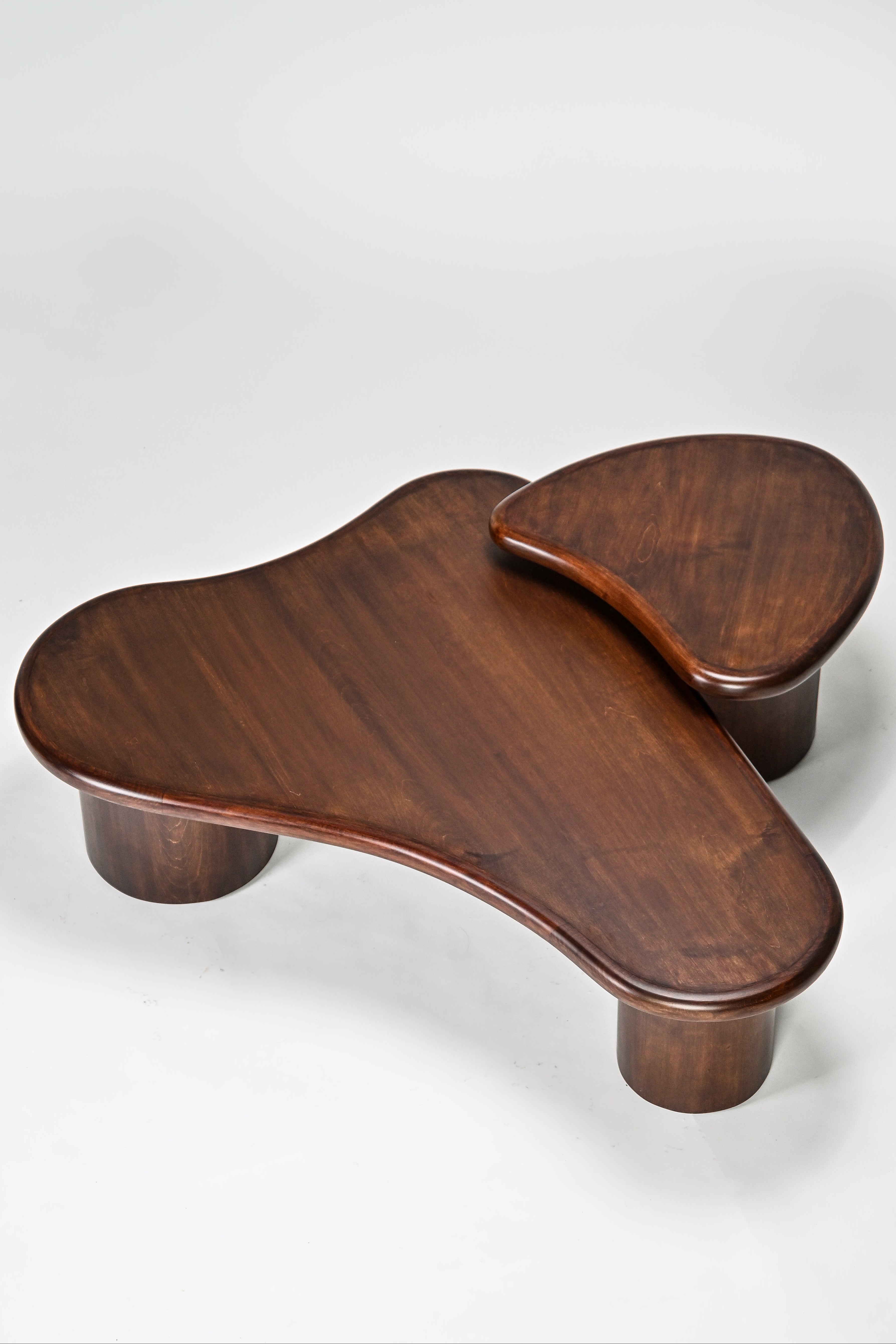 Wooden footstool with a unique design on a white background