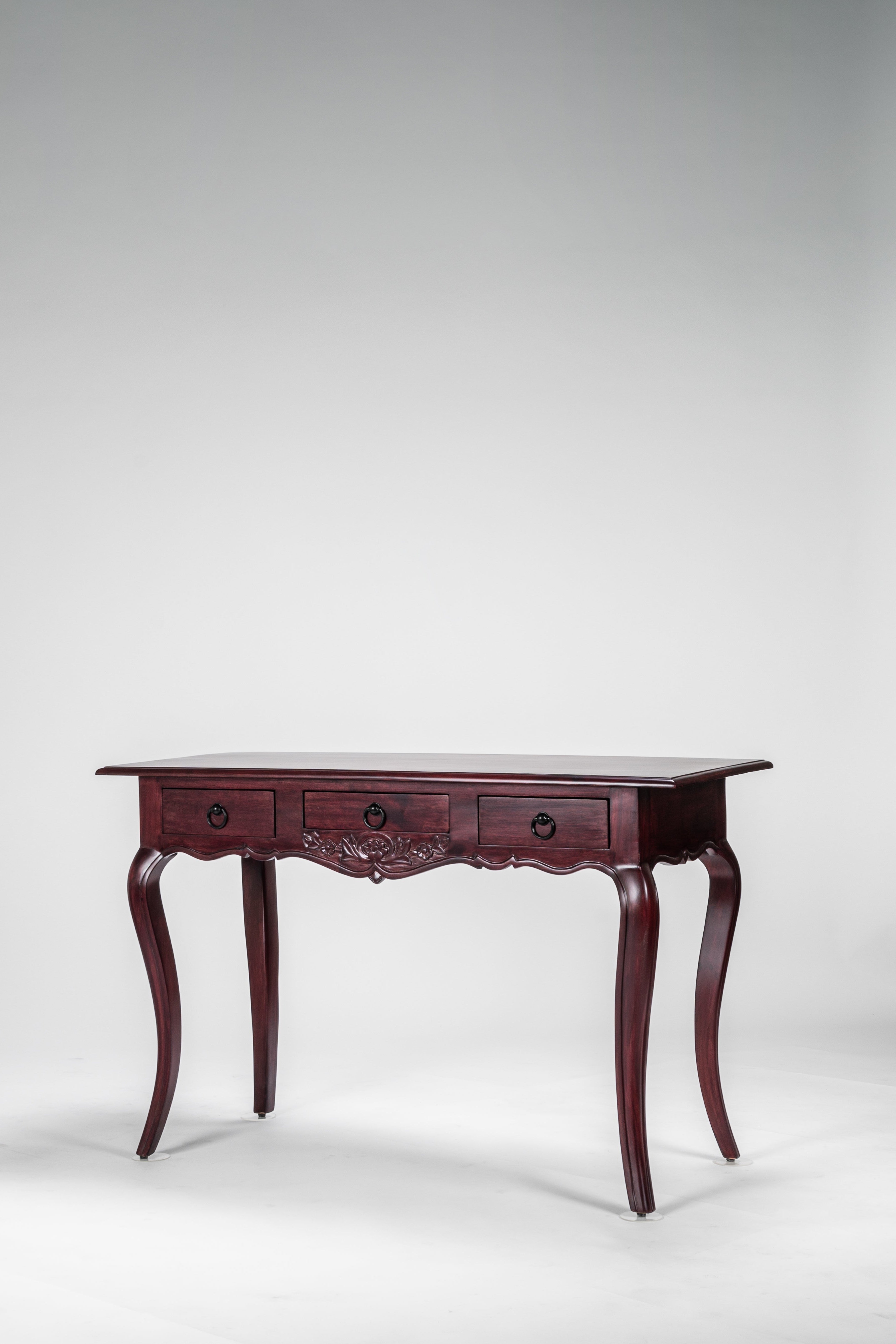 Wooden desk with three drawers on a white background