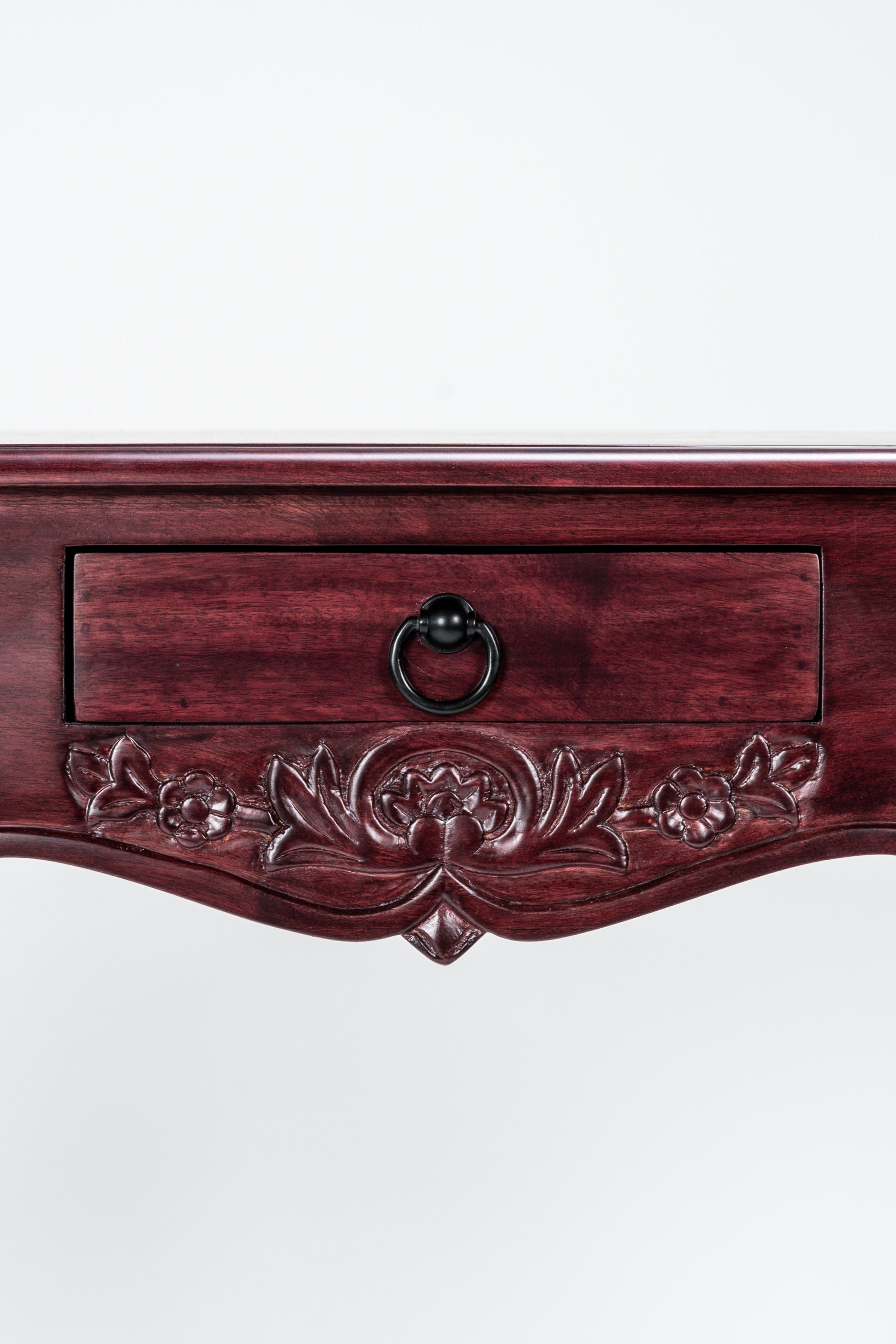 Wooden console table with floral carvings and a drawer on a white background