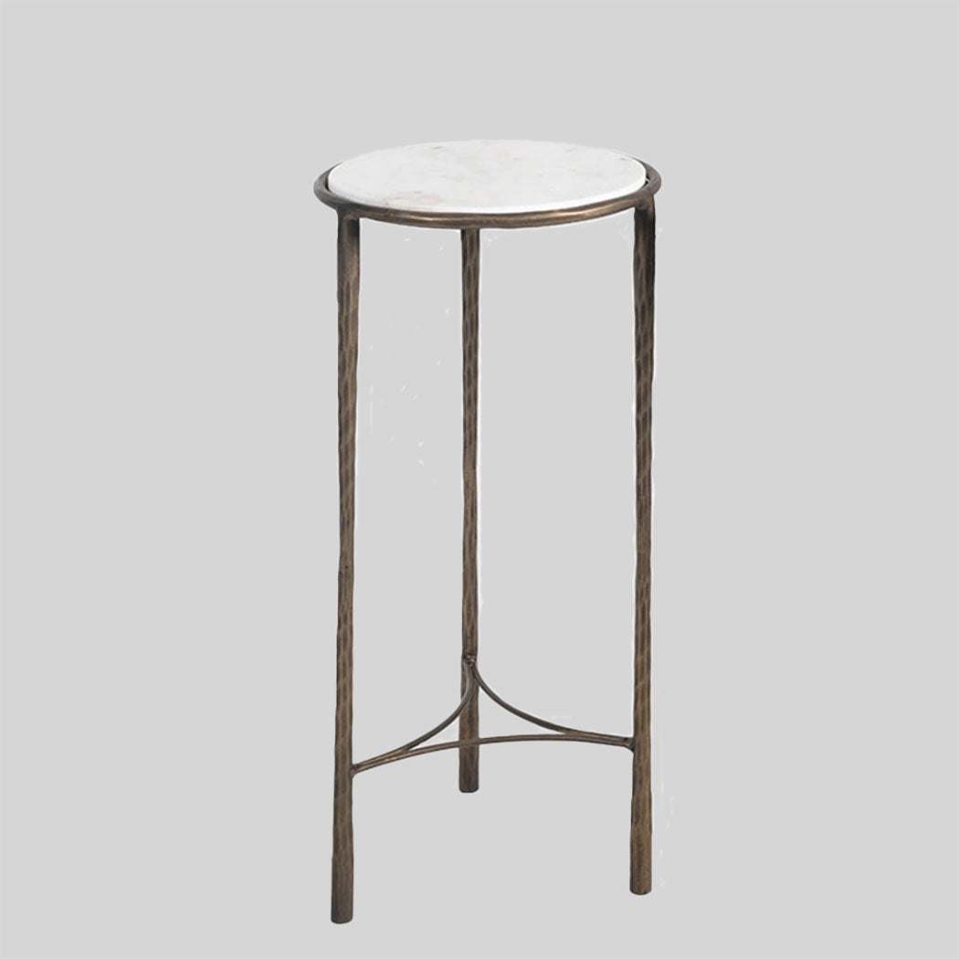 Small round table with marble top and bronze base on a gray background