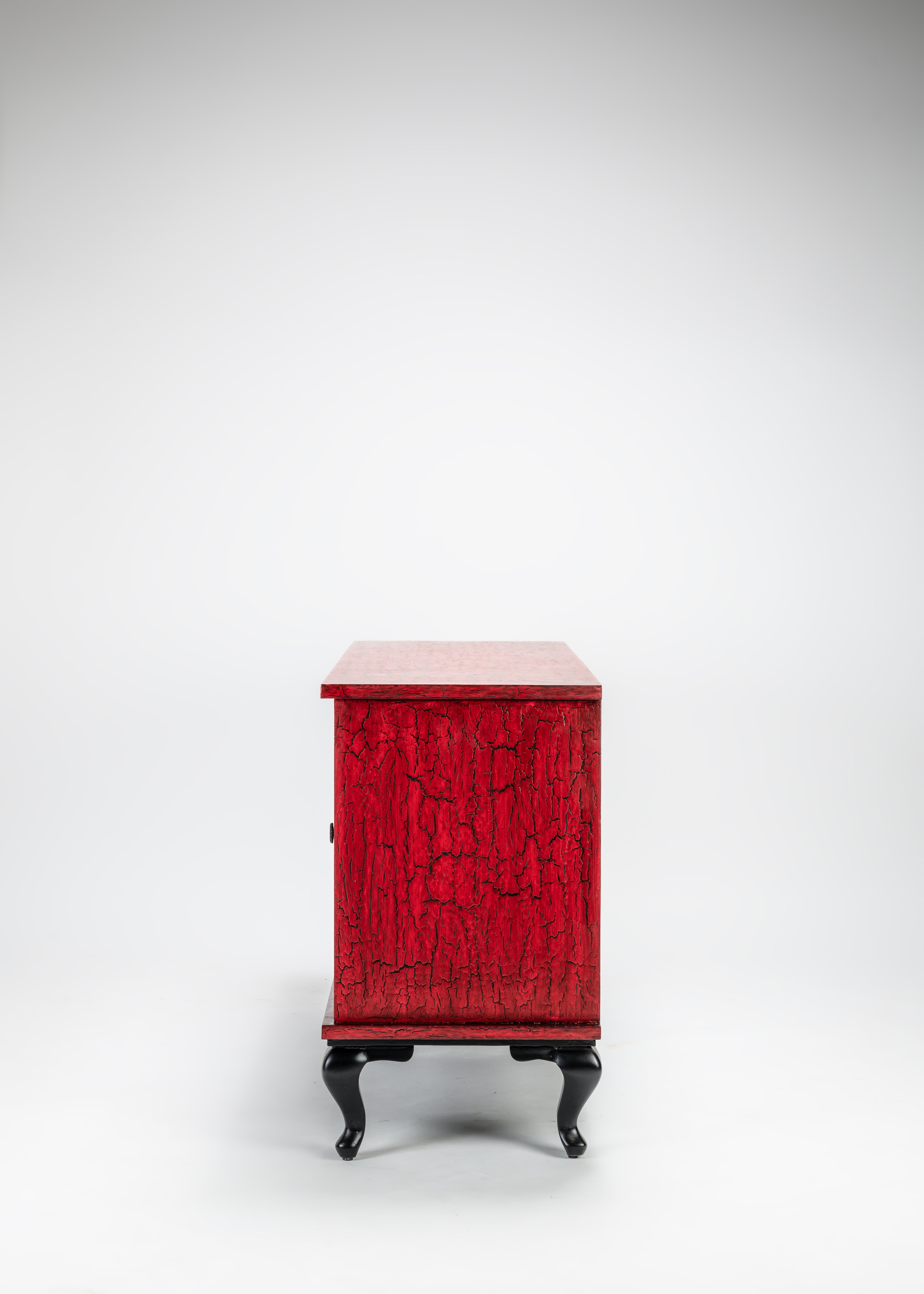 Red textured cabinet with black legs on a white background