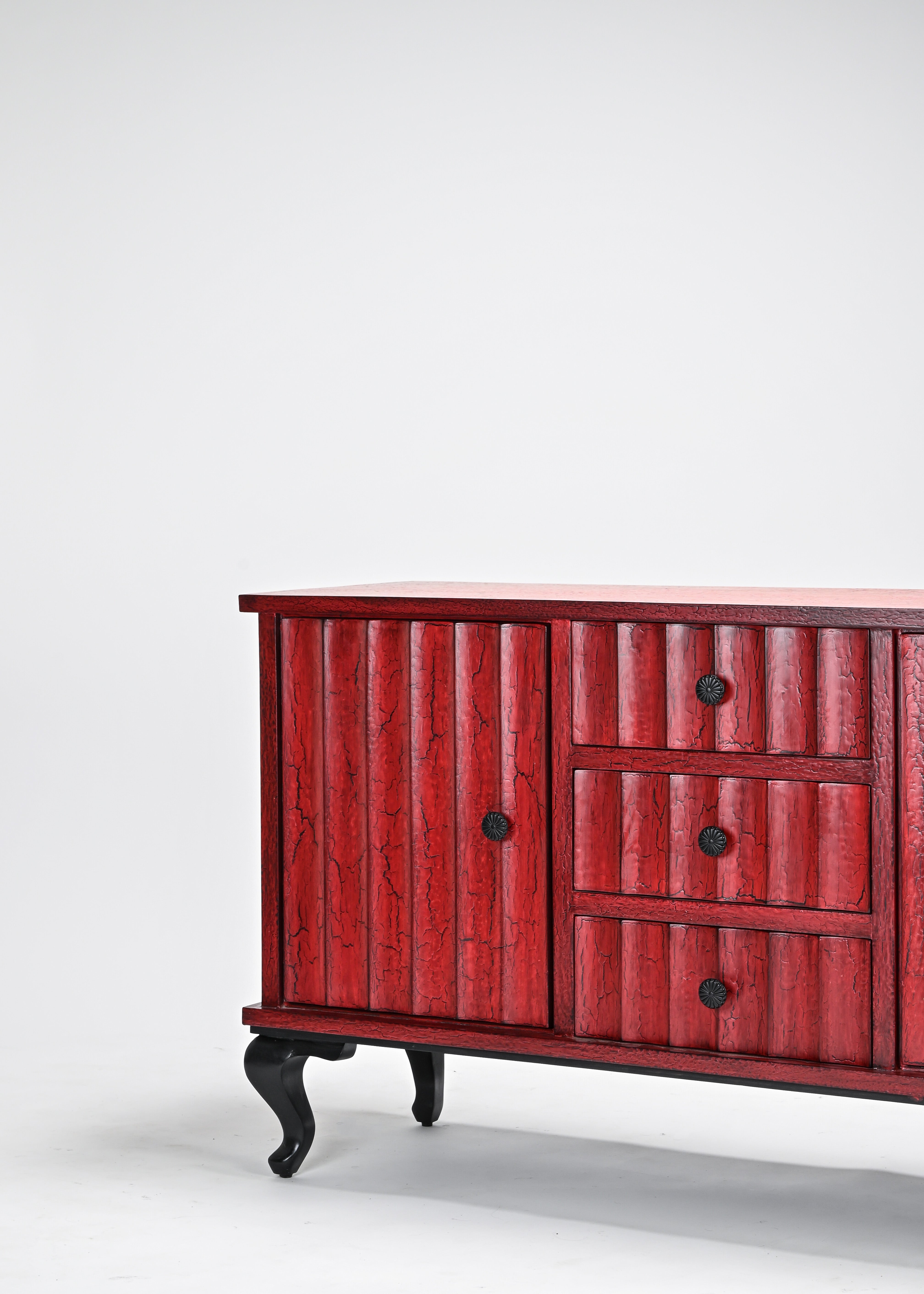 Red dresser with black legs on a white background